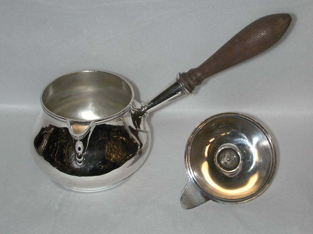 Antique silver lidded brandy saucepan made by Pittar and Co of 9 Old CourtHouse Street,Calcutta.
The term, Indian Colonial Silver, refers to silver manufactured by European silversmiths working in colonial India and making objects for the benefit