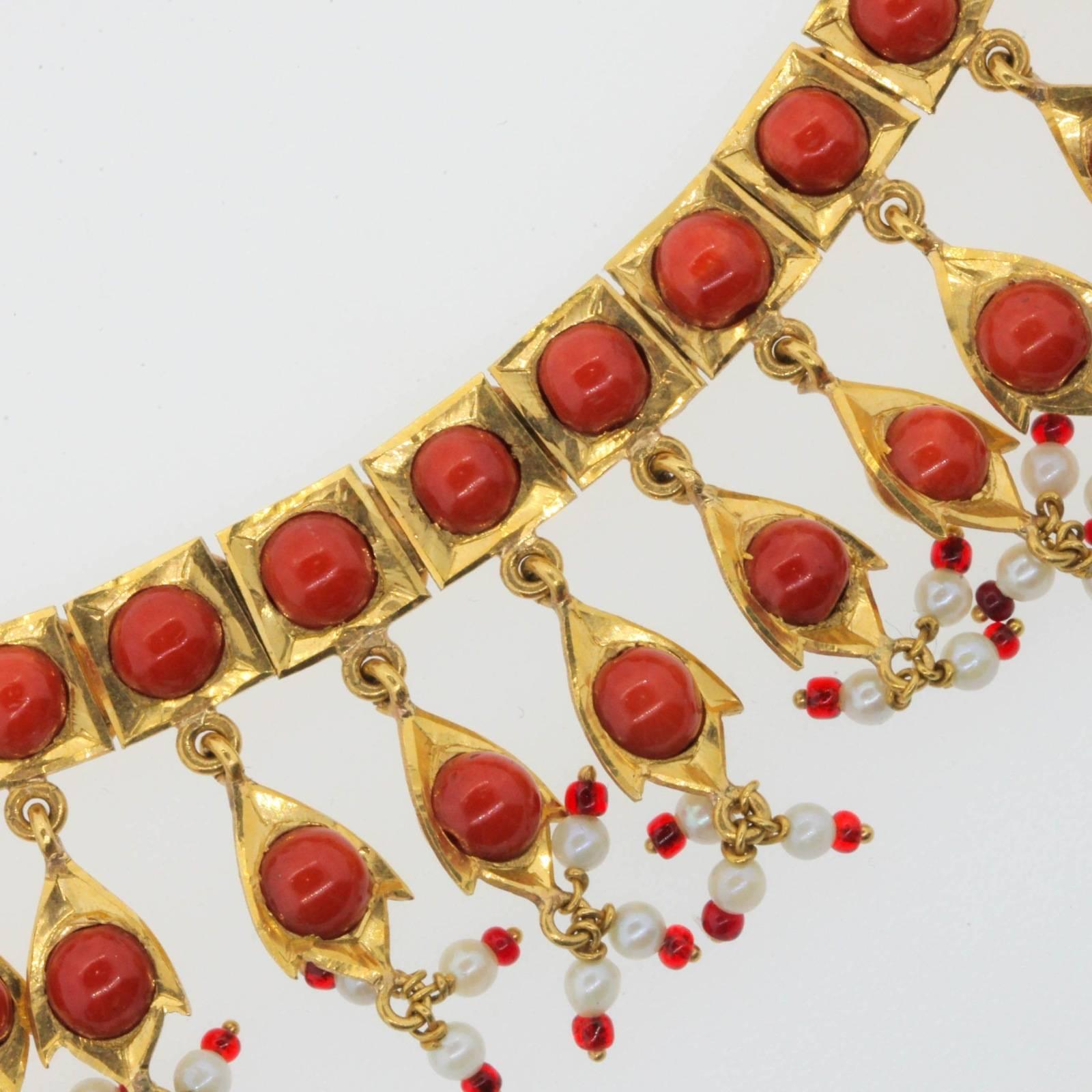 Inspired by India's Maharajas from the 1500s, is this lovely one of a kind Coral and 20KT yellow gold necklace.  The line of square articulated links are set with Coral beads, each dangling  a Coral and gold pendant  completed with  fresh water Seed