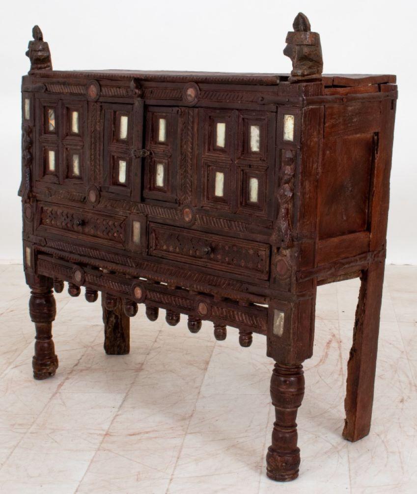 Indian Damachiya Dowry Chest, Rajasthan, circa 1900, with finial headed rectangular top above two intricately paneled doors supported on four legs. 37