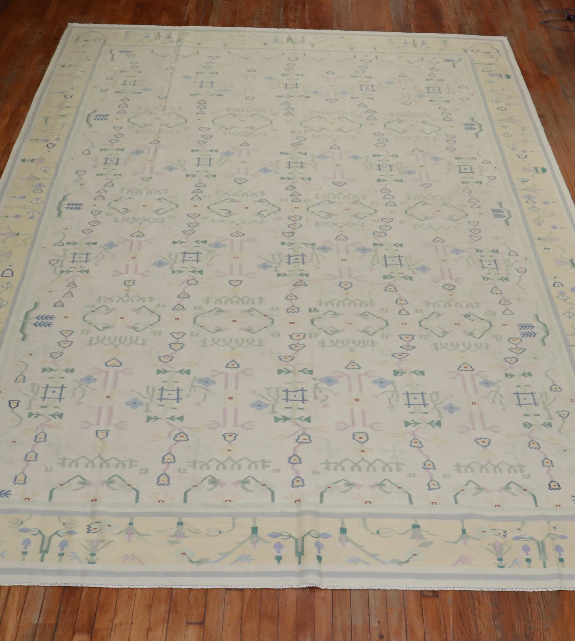 Room size Indian Dhurrie flat-weave carpet in warm pastel tones on a white field and mellow yellow border. Piece has elements from 20th century Scandinavian flat-weaves. The weaver might have used this when knotting the piece,

circa third quarter