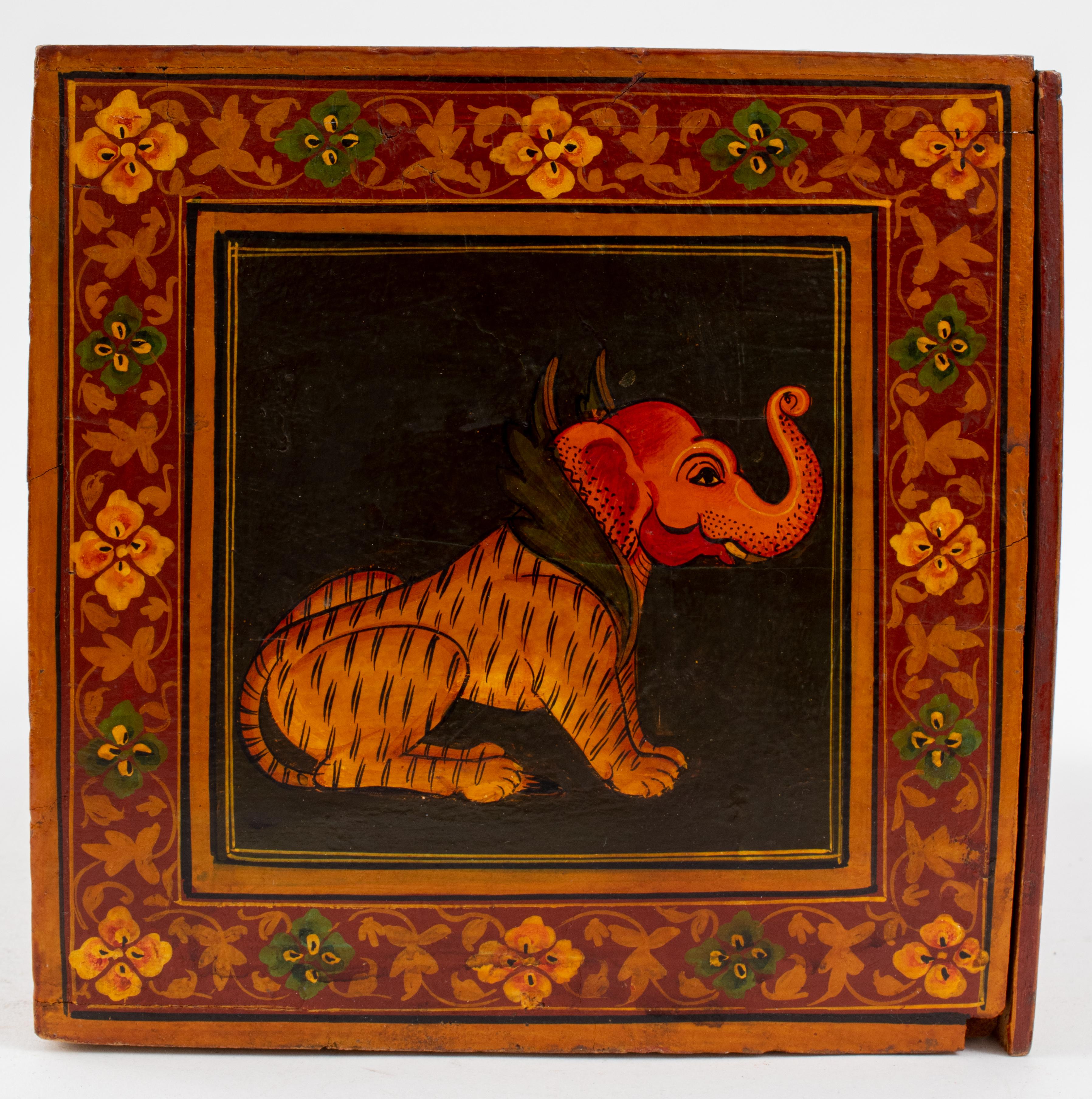 Indian wooden box with hand-painted images of chimeras, Ganesha, and a woman. The box opens to reveal one large drawer and three small ones. 
The drawers feature metal accents. 
Measures: 8