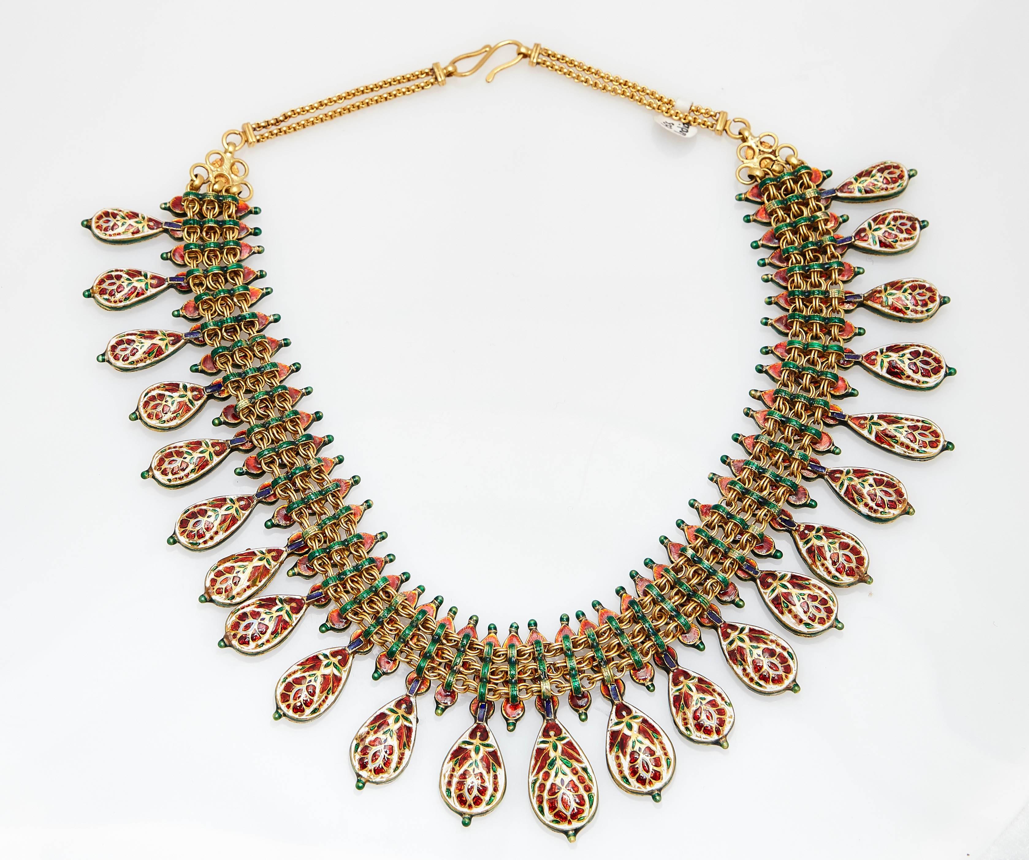 An impressive vintage Kundan Meena Indian gold necklace with drop shaped emeralds, the back typically enamelled. 

Kundan is a traditional form of Indian gemstone jewellery involving a gem set with gold foil between the stones and its mount, usually