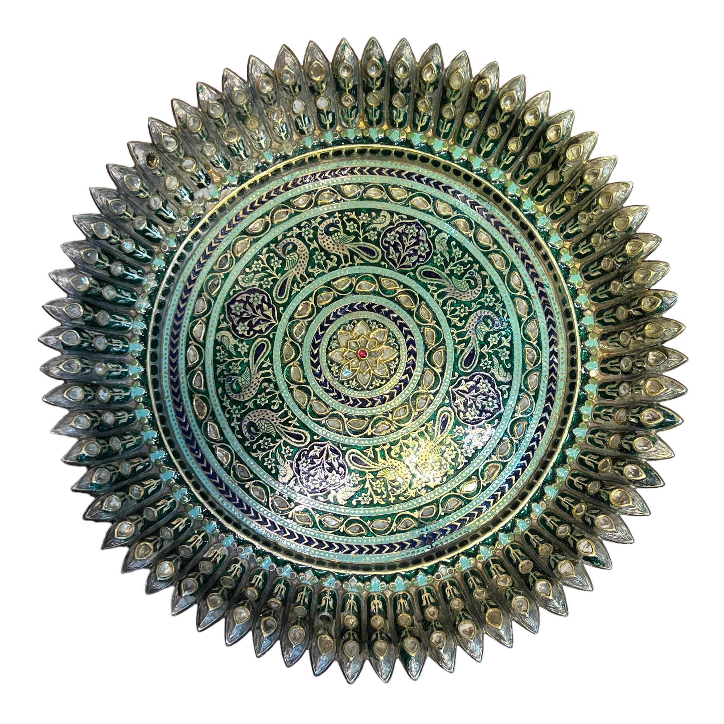 Unsere prächtige antike, mit Edelsteinen besetzte und emaillierte silber-vergoldete Tazza aus Nordindien, um 1800, zeigt eine lotusförmige Schale, die mit konzentrischen Ringen aus Vogel-, Blumen- und geometrischen Motiven in grüner, blaugrüner und