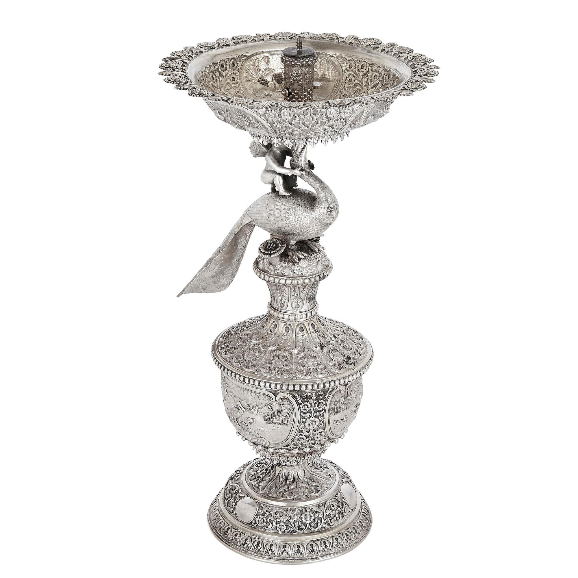 Indian engraved silver table fountain by Oomersi Mawji & Sons
Indian, late 19th century
Measures: Height 40cm, width 23cm, depth 21cm

This exceptional table fountain is by the celebrated Indian silversmiths Oomersi Mawji & Sons, which is