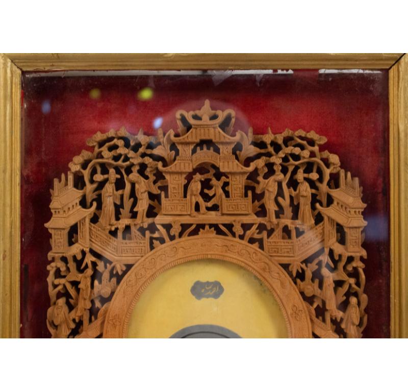 Asian Indian style filigree carved sandalwood wall plaque under glass with a portrait of a young man.