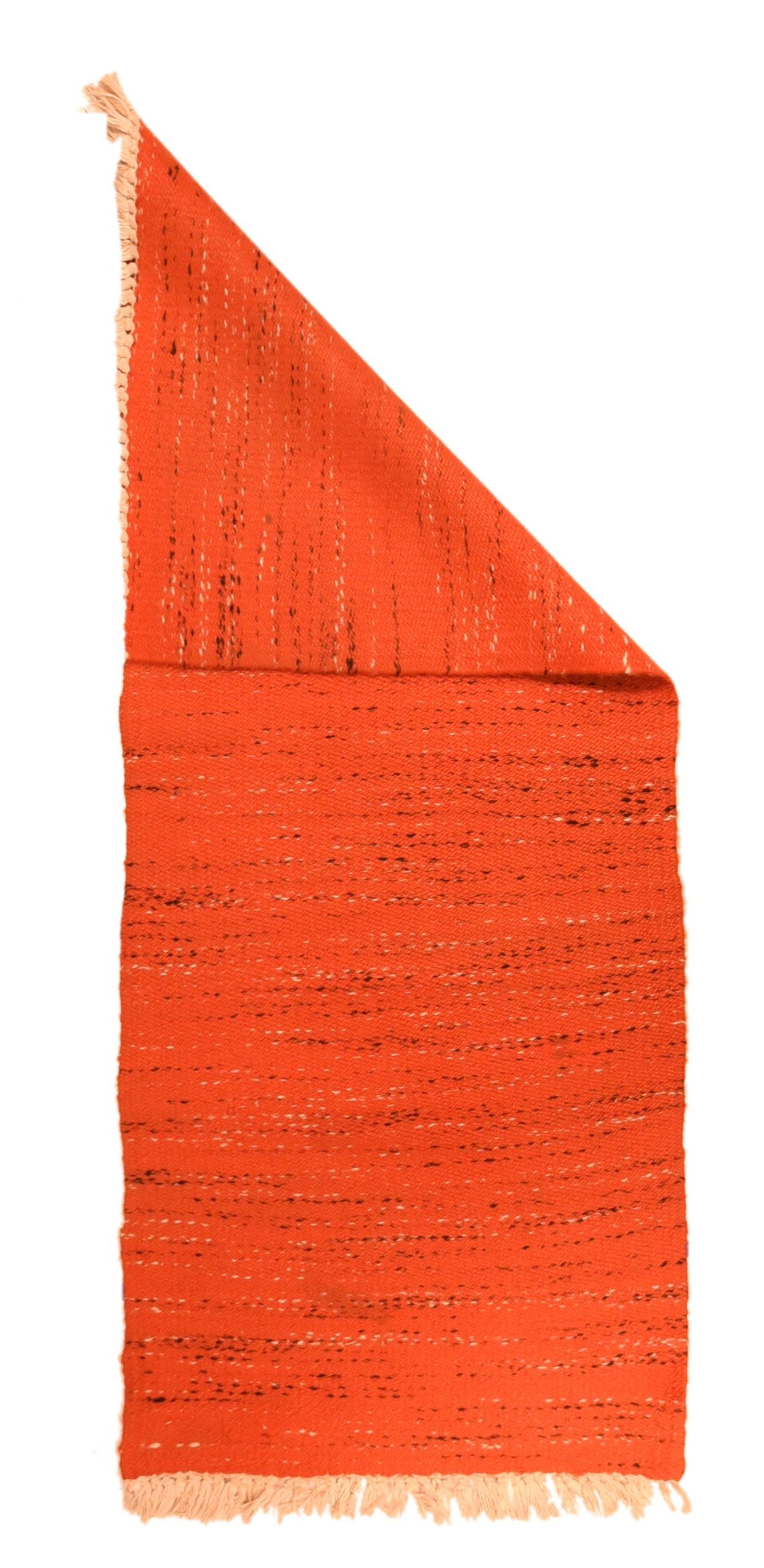 Indian Flat Weave Rug 2'9'' x 6'4''. The rust-red wool field of this plain weave kellegi (long rug) is randomly interrupted by broken streaks of yarn in eggshell and brown. No pattern or order, just whatever colors the weaver picked up.S lightest