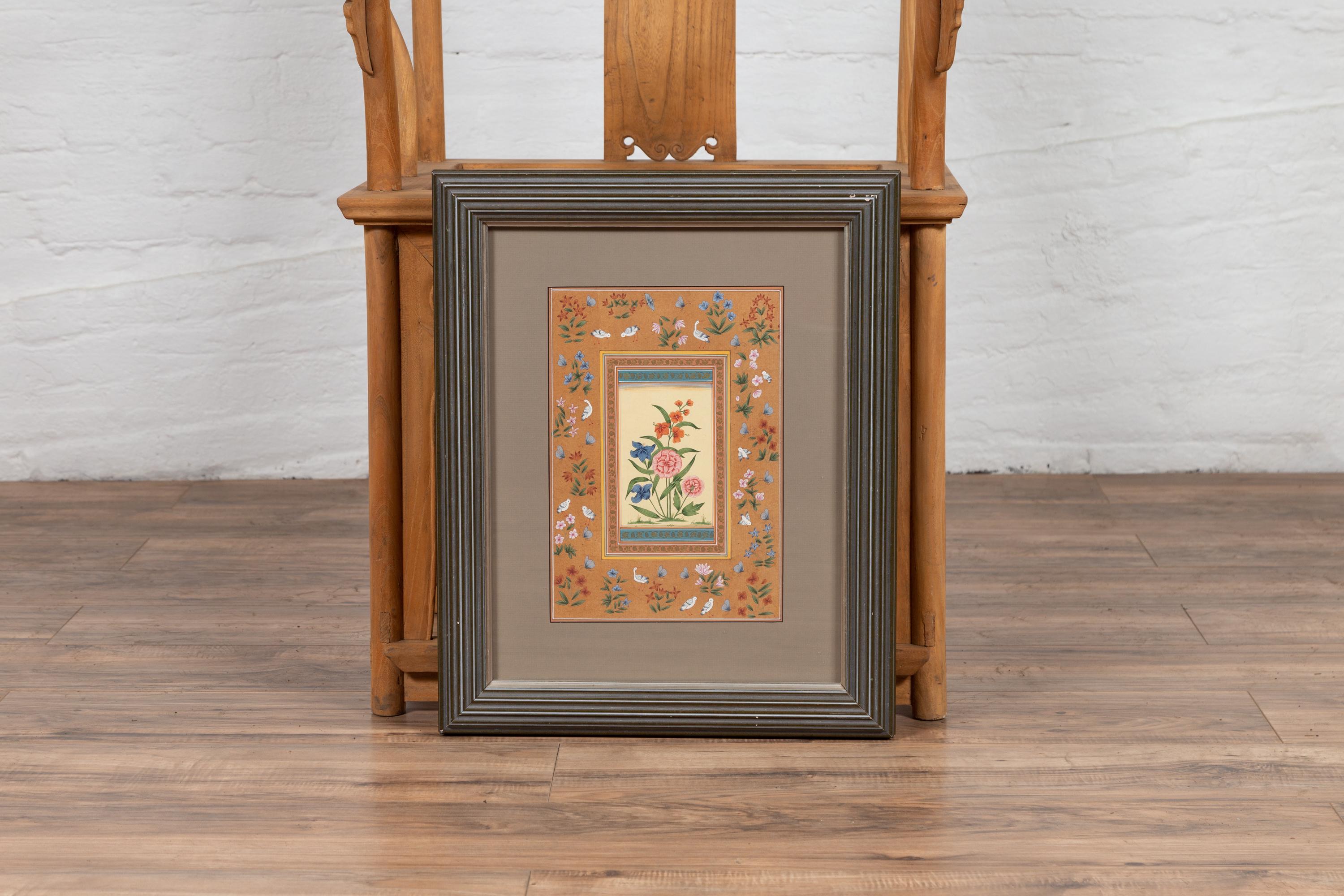 An Indian vintage framed still-life of vertical format from the mid-20th century, with pink, orange and blue flowers surrounded by birds. We have four similar pieces all together that would create a great vignette, they are priced and sold