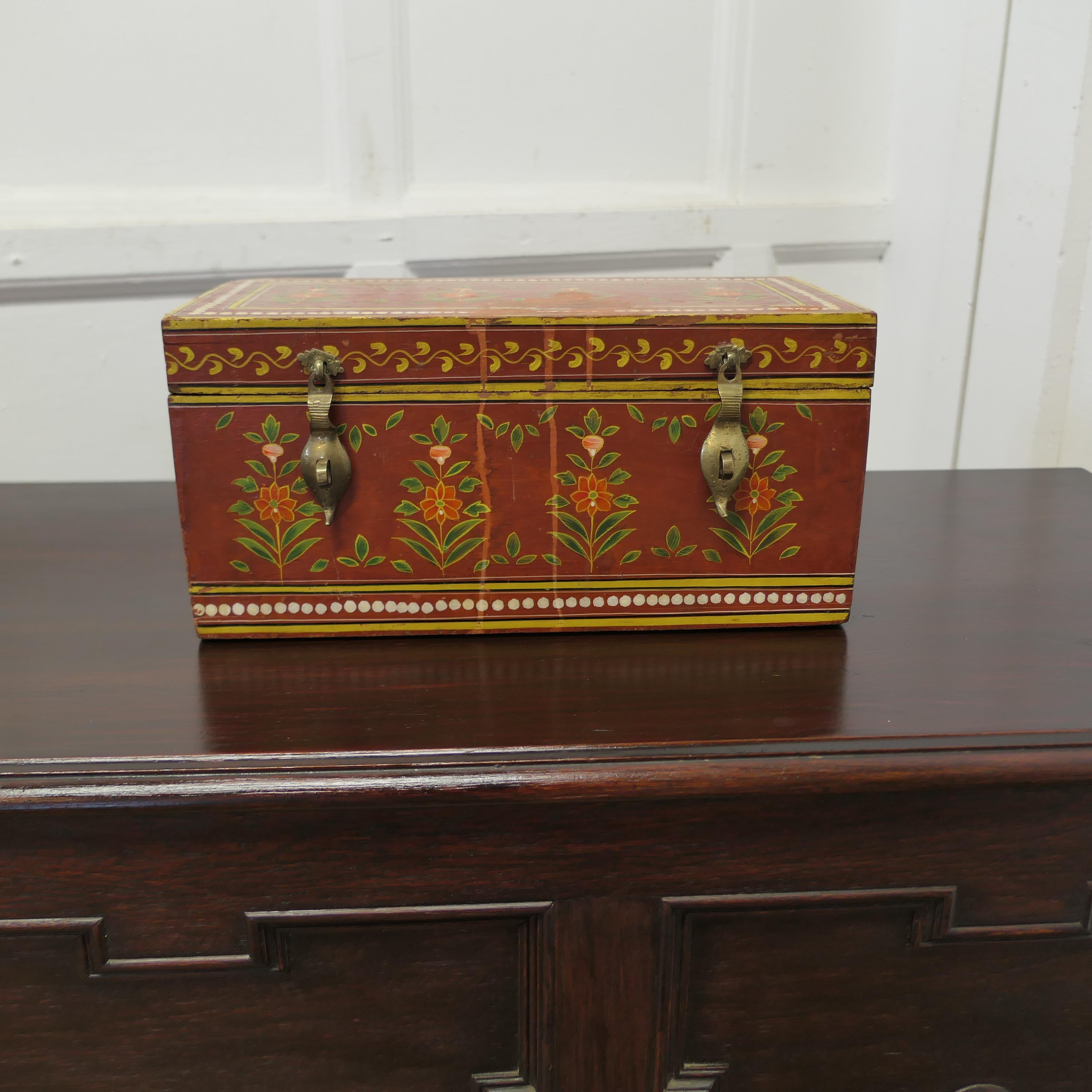 Indian Folk Art Painted Treasure Chest

This is a pretty piece, the chest is painted in the detailed Indian Folk Art Style in warm red colours showing stylised leaves and flowers
The painted decoration is very attractive and it has a little wear on