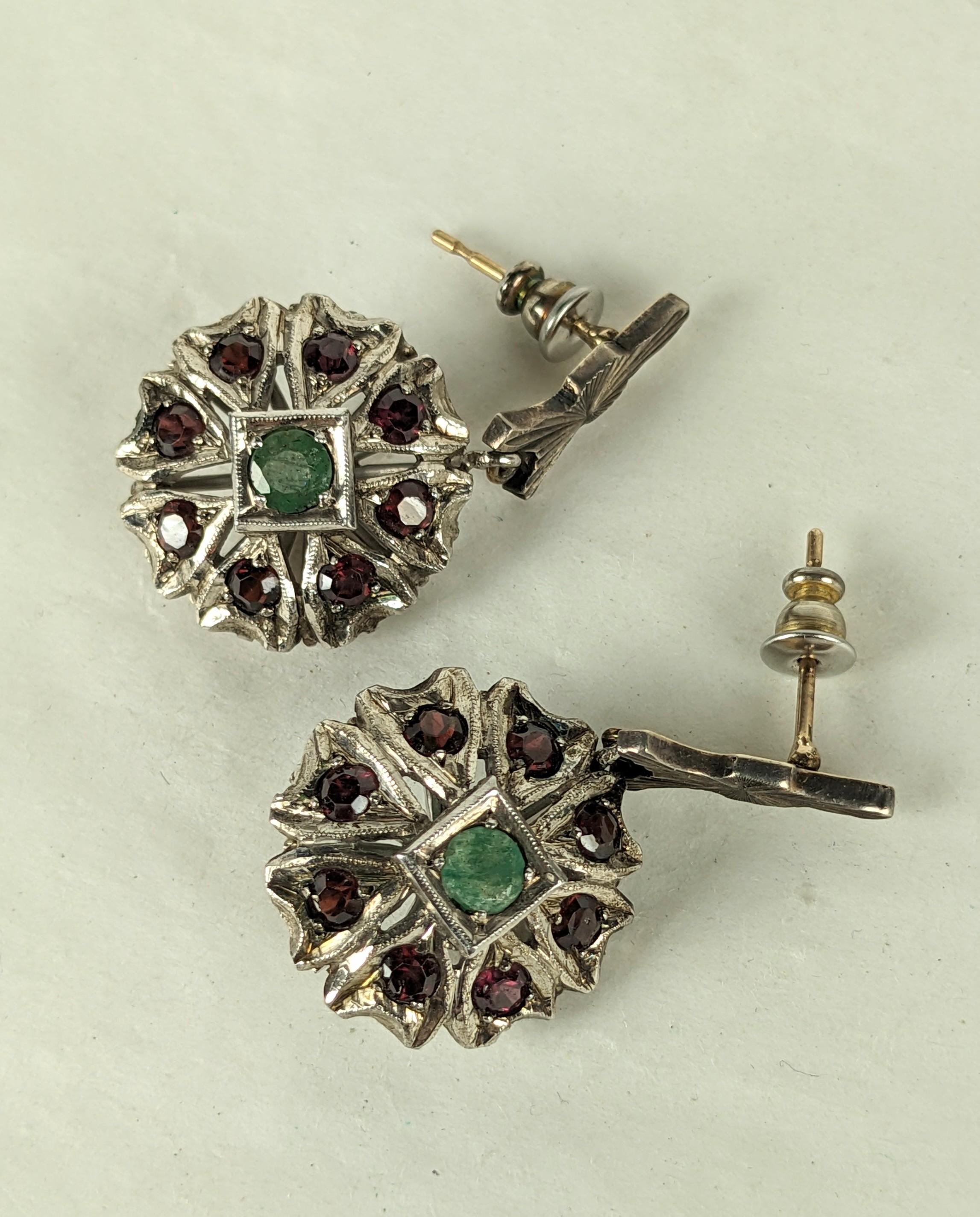 Indian Garnet and Emerald Drop Earrings set in silver from the 1950's. Bombe flower motif set with garnets in the petals with a central emerald. Pierced fittings. 1950's India. 1.5