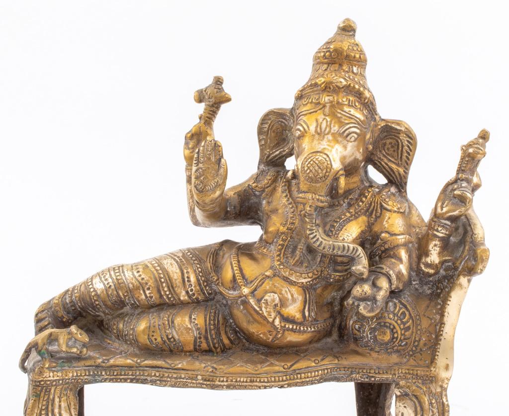 Antique Indian gilt bronze statue sculpture of the Hindu Lord Ganesh lying on a bed with a mouse. 11.5