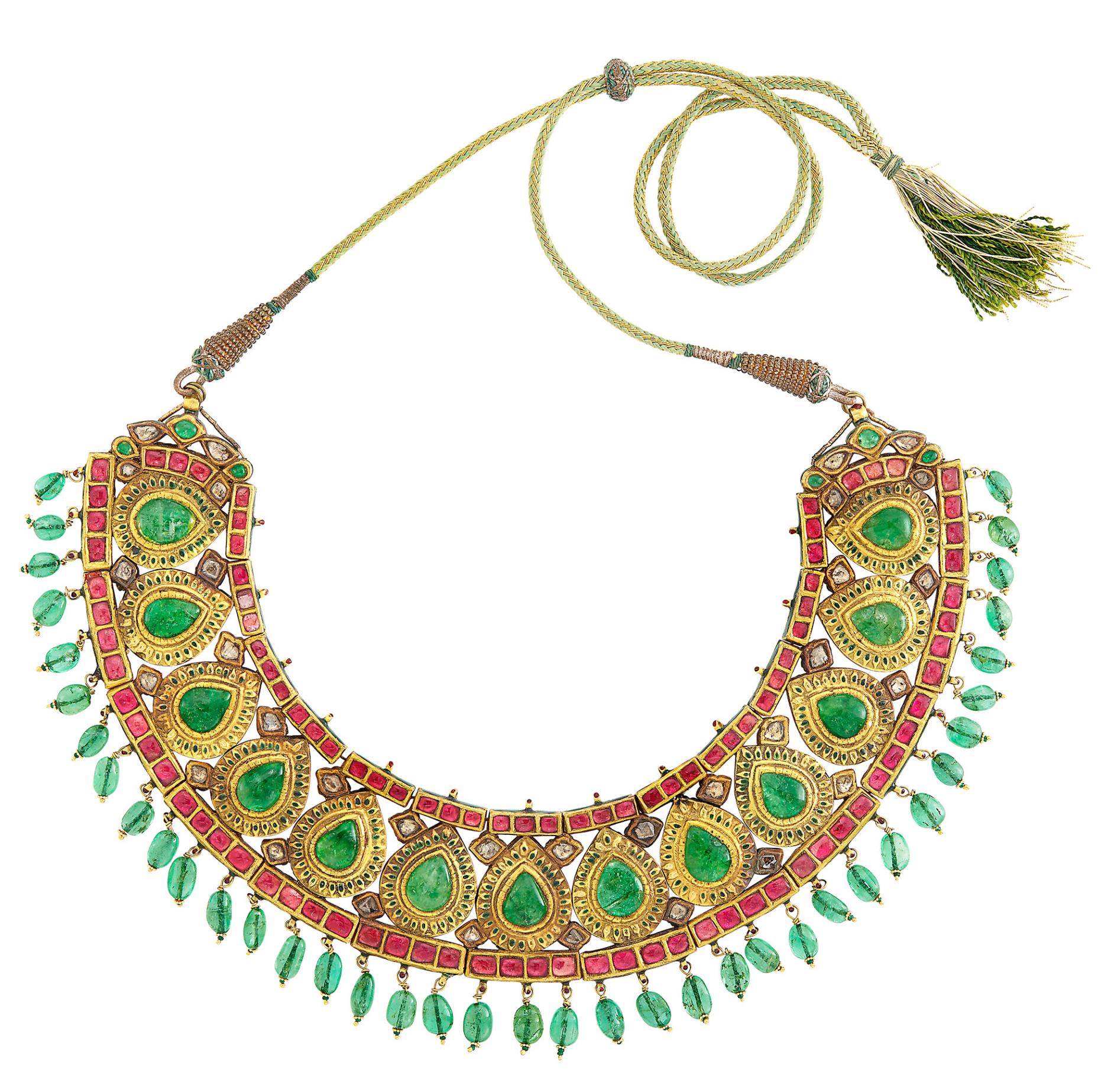 Indian Gold, Foil-Backed Emerald, Ruby and Synthetic Ruby and Diamond, Emerald Bead and Jaipur Enamel Fringe Necklace. The curved bib centering 13 pear-shaped foil-backed emeralds, within pear-shaped frames decorated with oval green enamel spades,