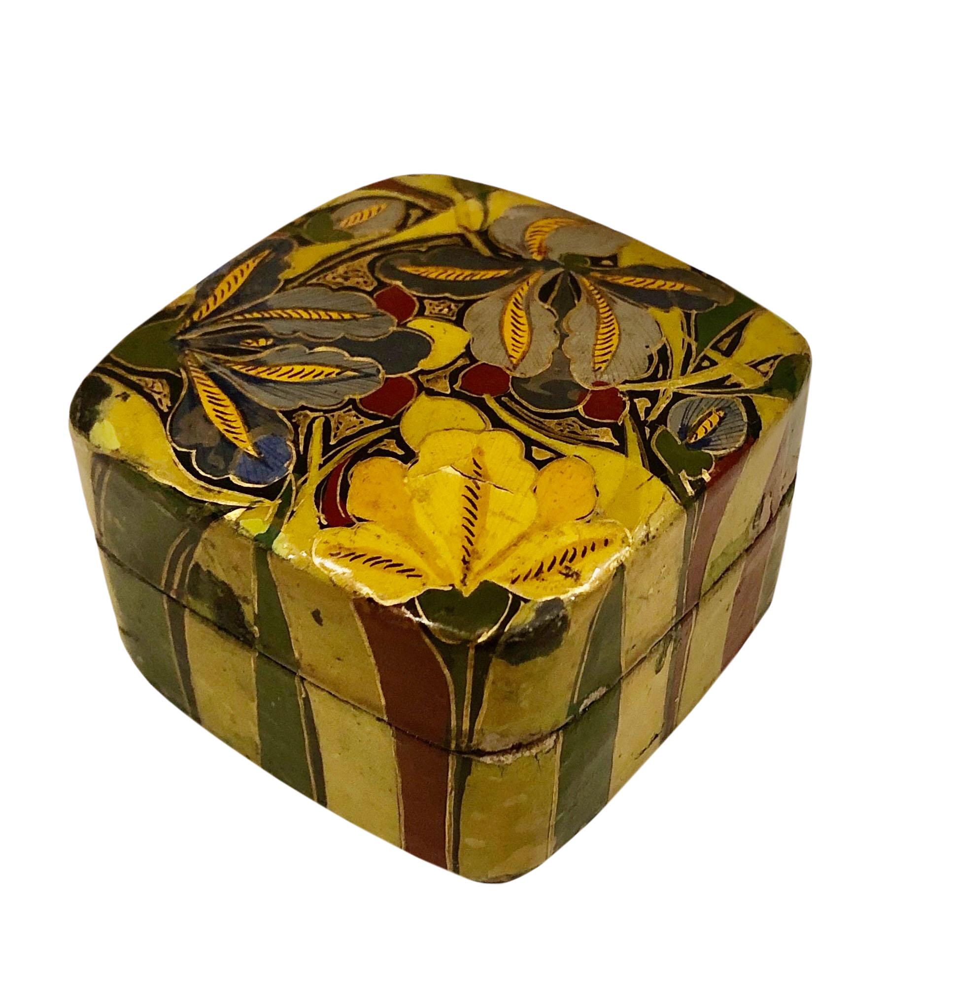 A hand painted papier mâché square box with stripes on the sides and flowers on the top. It is signed Kashmir. Circa 1960s.