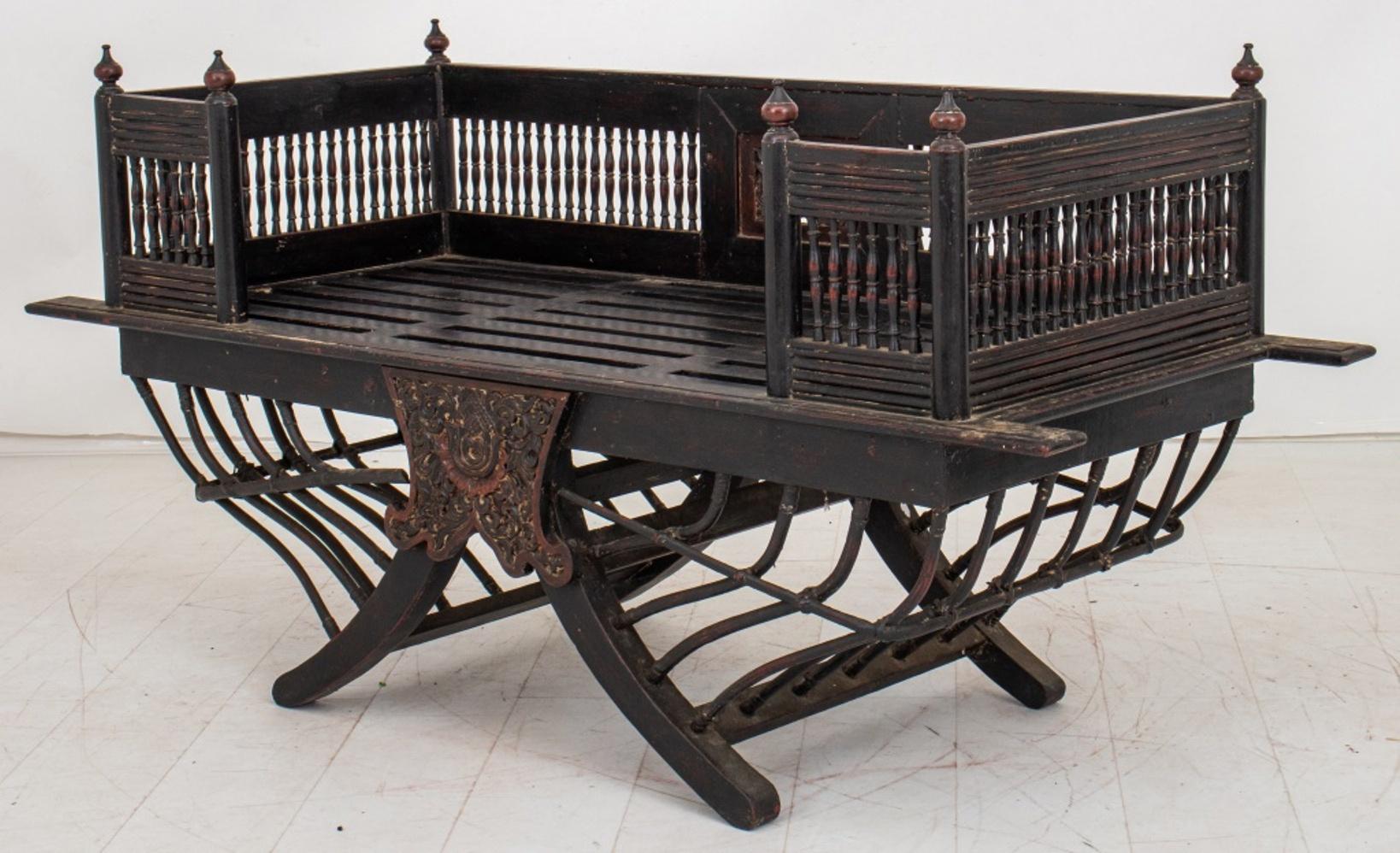 Indian Howdah, or elephant saddle, in polychromed rosewood, the rectangular seat with galleried sides above an arching support for the back of the elephant. In good antique condition. Wear consistent with age and use.

Dimensions:   33