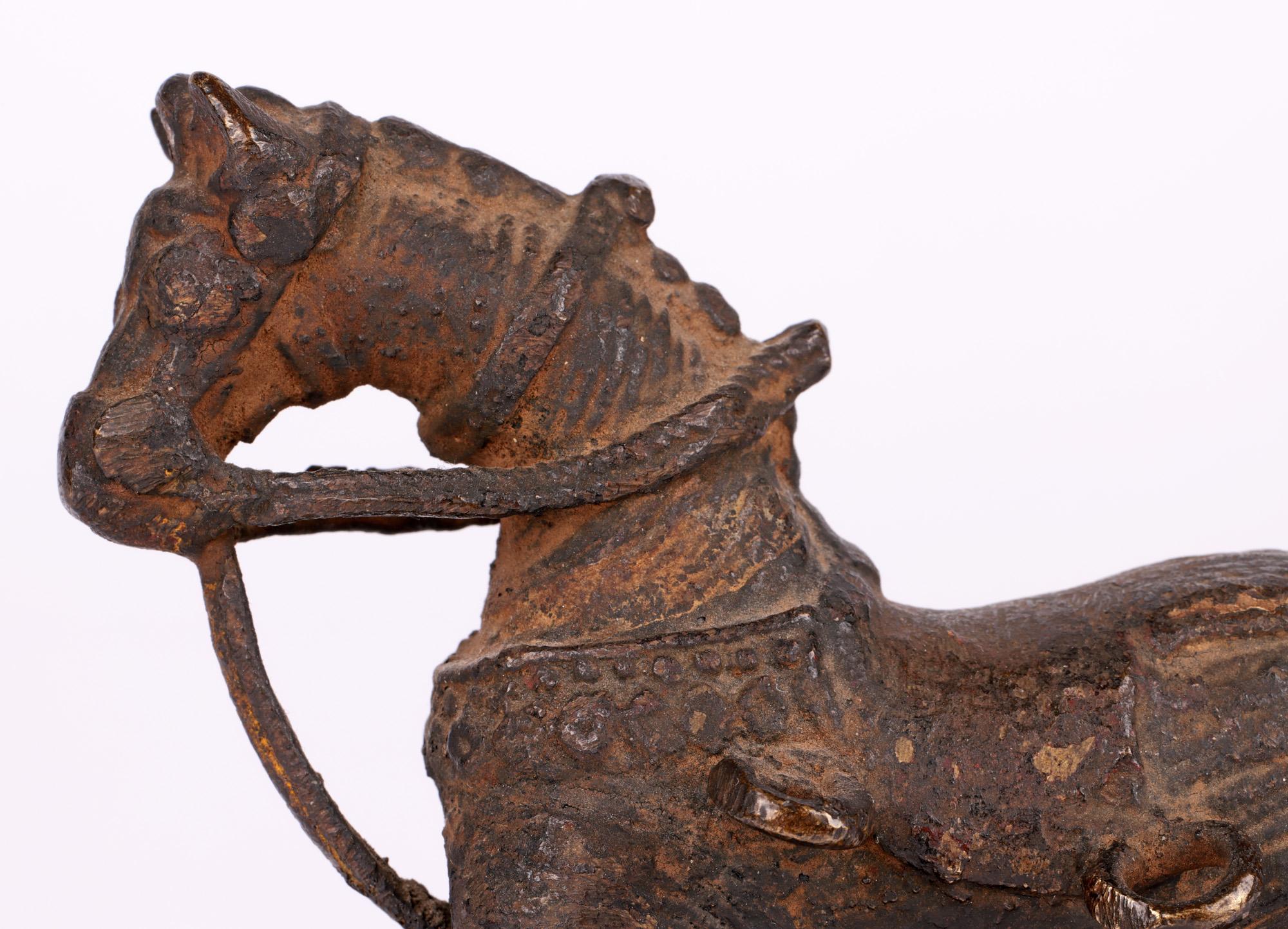 A good antique bronze temple horse on wheels toy originating from Jhansi City in Bundelkhand in Northern India and dating from the 19th century. The Hindu region of Bundelkhand is well known for its bronzes this early example is cast in bronze using