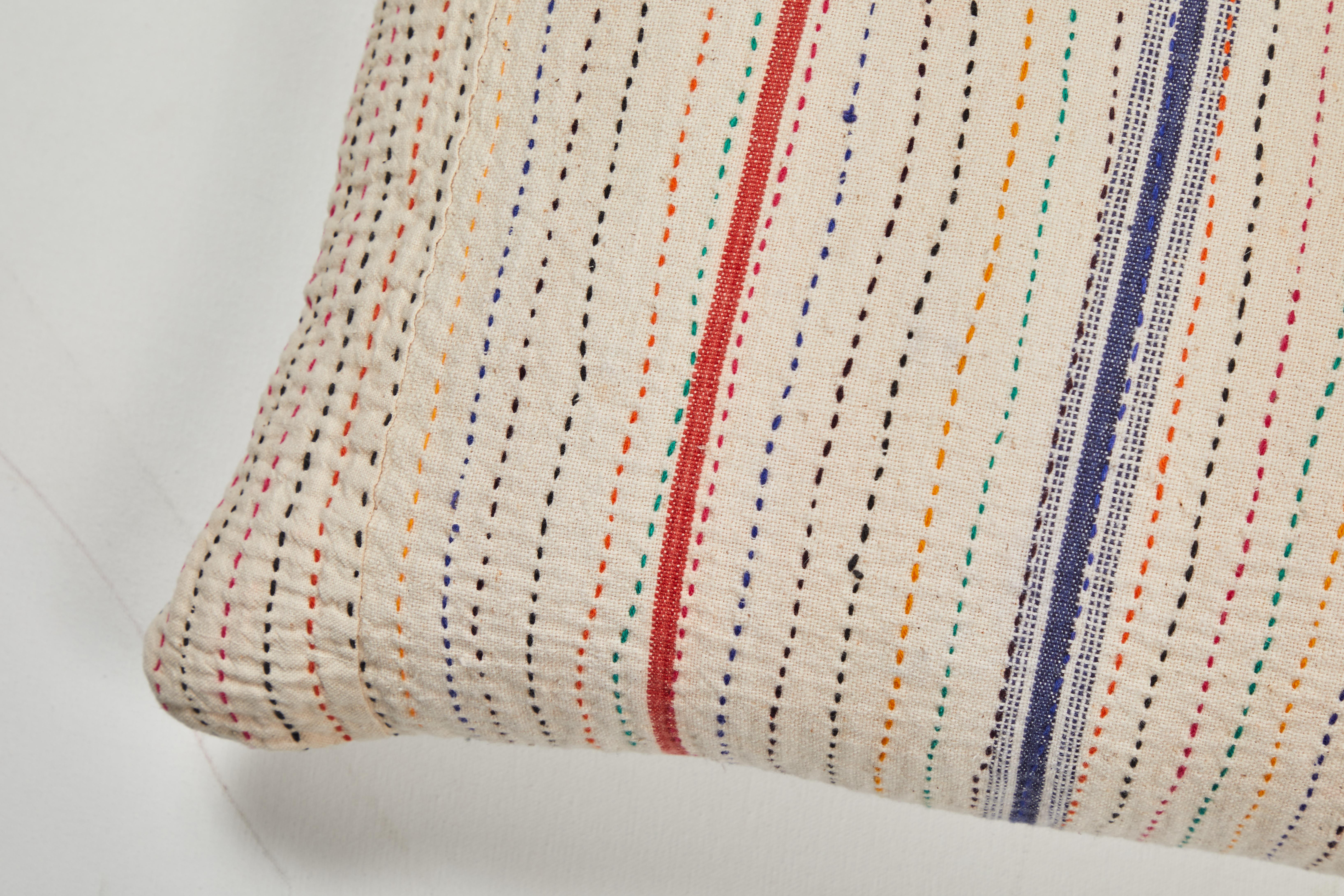 Vintage cotton canvas with multicolored quilting stitches. Natural linen back, invisible zipper closure and feather and down fill.