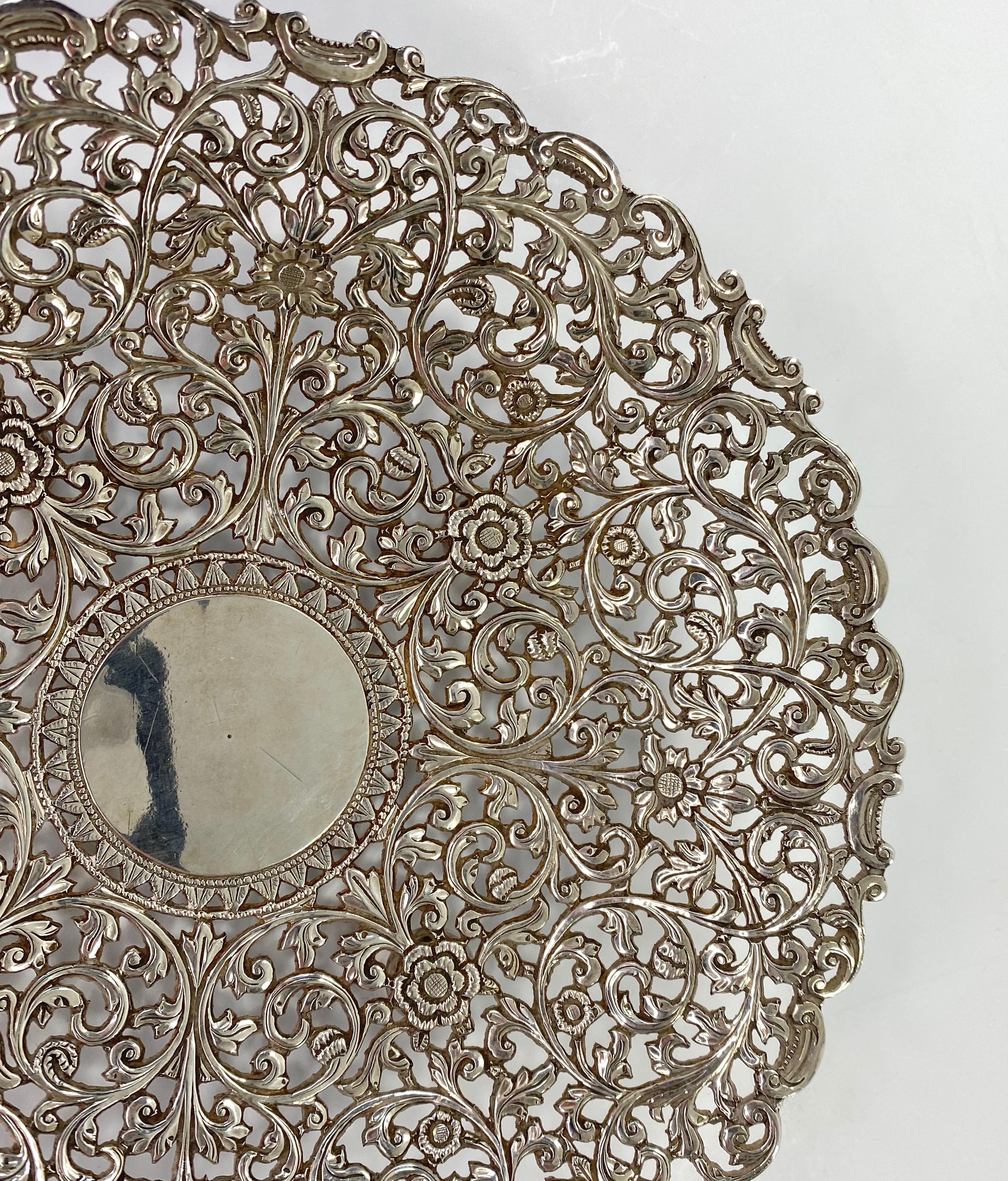 A fine Indian Kutch reticulated silver salver. Having a central circular cartouche, edged with a continuous band of acanthus leaf. Surrounded by a finely reticulated, complex design of scrolling foliage, terminating in flowerheads, in Islamic style,