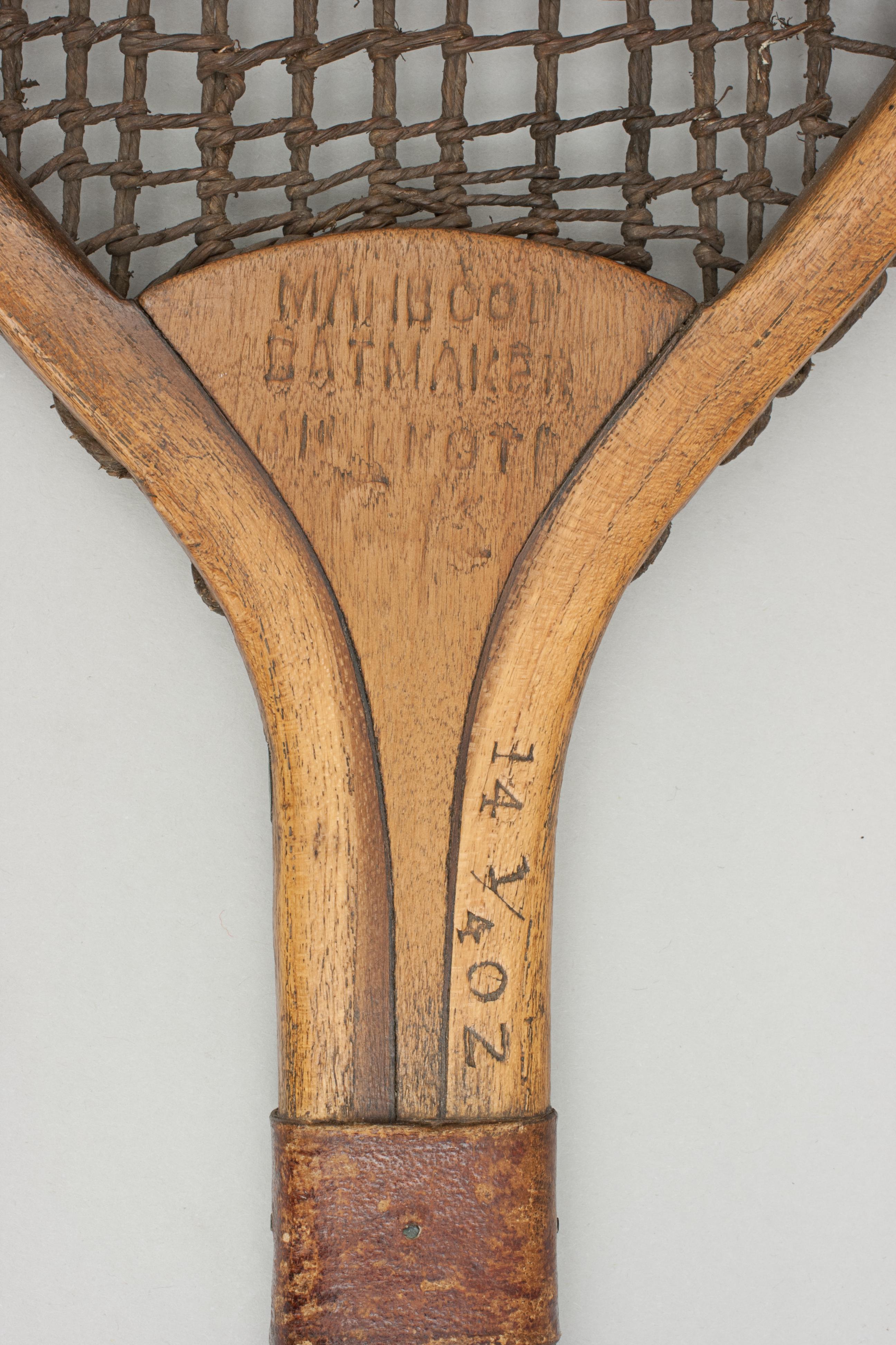 A fine example of a flat top lawn tennis racket by Mahboob of Sialkot (Punjab). The racket has good, original double stringing, 11 trebling to the top and none at the bottom. Not only is it unusual for its bulbous shaped handle with diamond shape