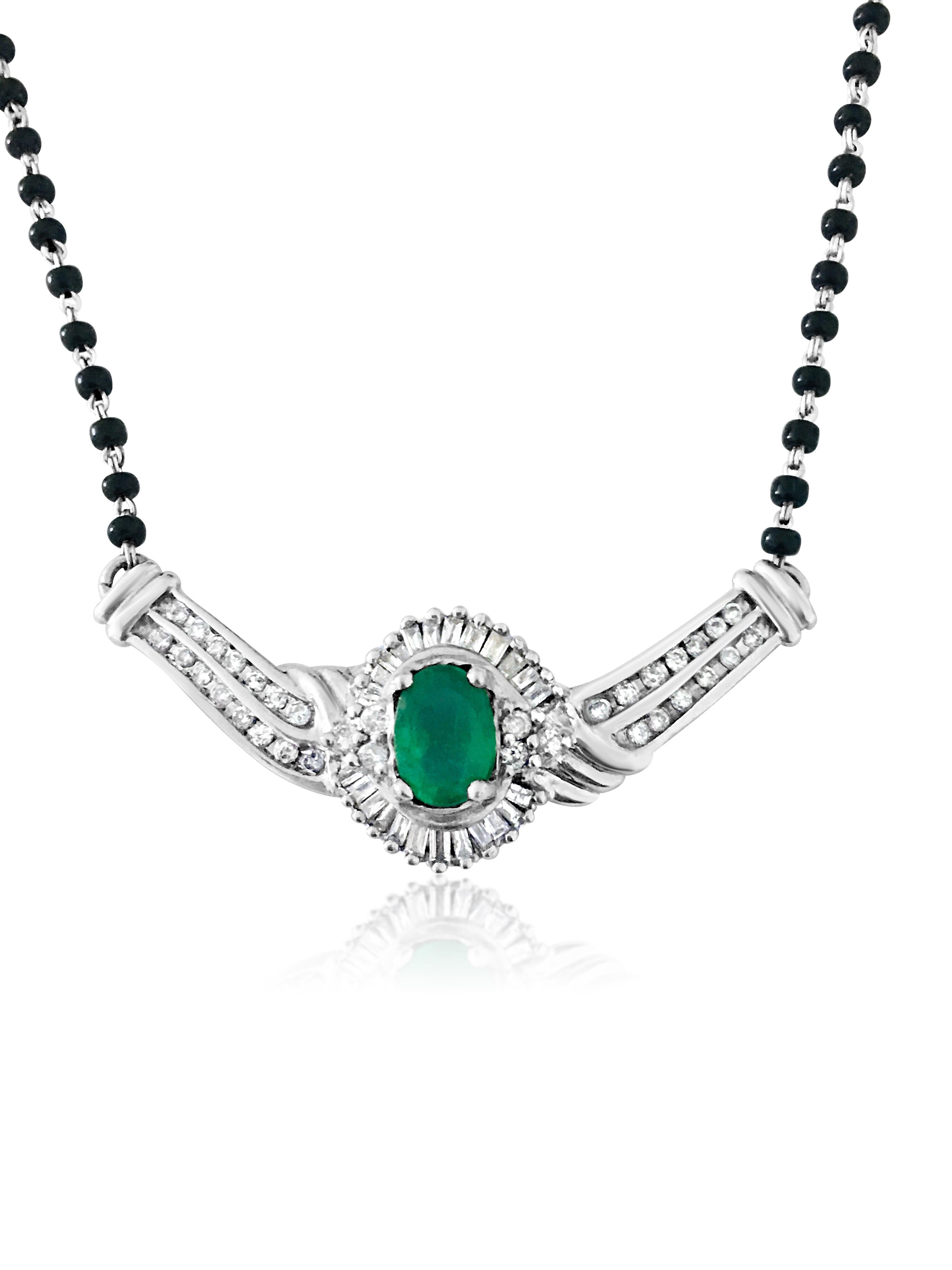 Beautiful Indian jewelry for women made with 14-karat white gold. The necklace features a stunning 3.00-carat Colombian emerald, a natural gemstone mined from the earth. The emerald is cut in an oval shape and securely set in prongs. The diamonds on