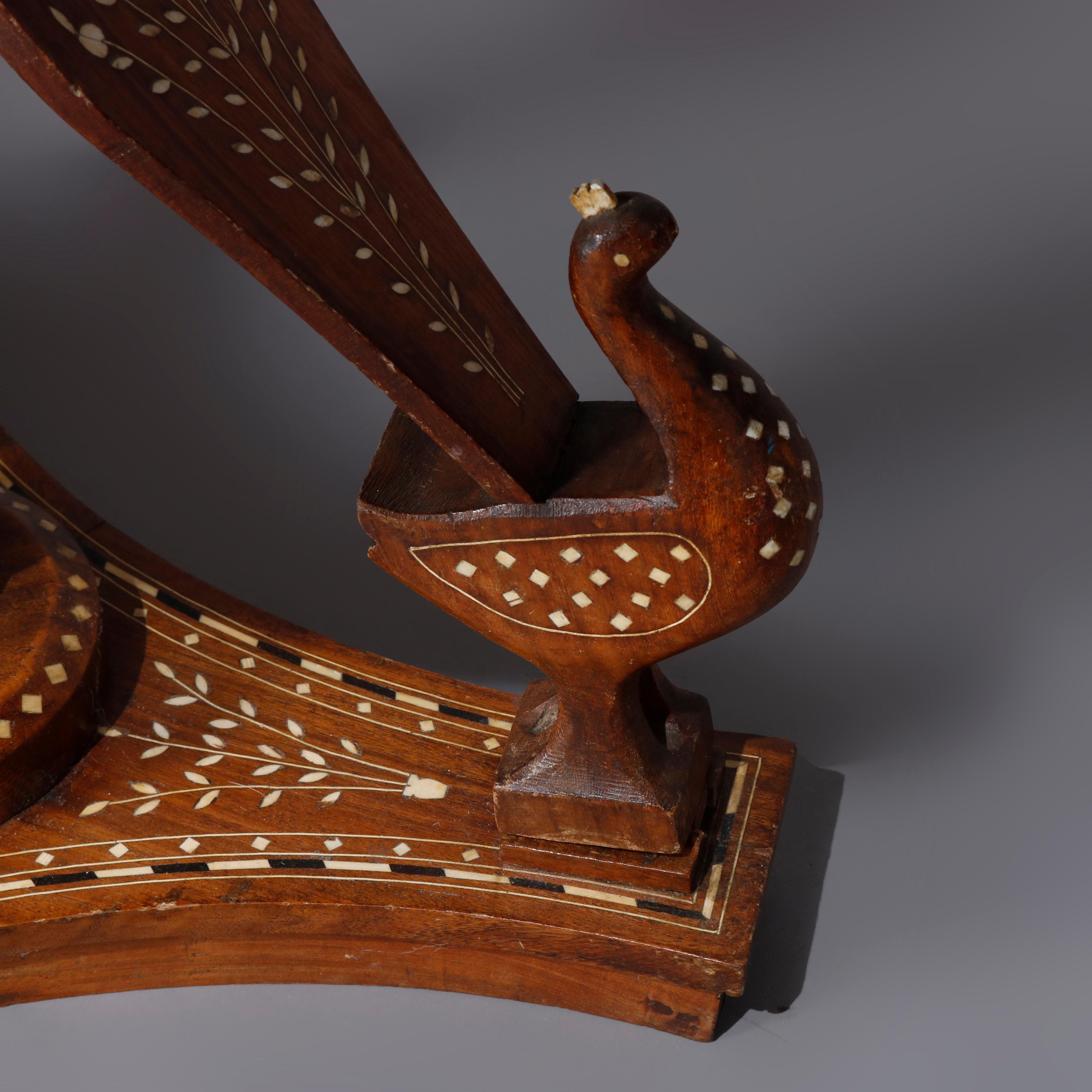 An Indian figural side table offers round top with intricately inlaid Persian design raised on carved and inlaid peacocks with central turned column and seated on foliate inlaid base, circa 1910

***DELIVERY NOTICE – Due to COVID-19 we are employing