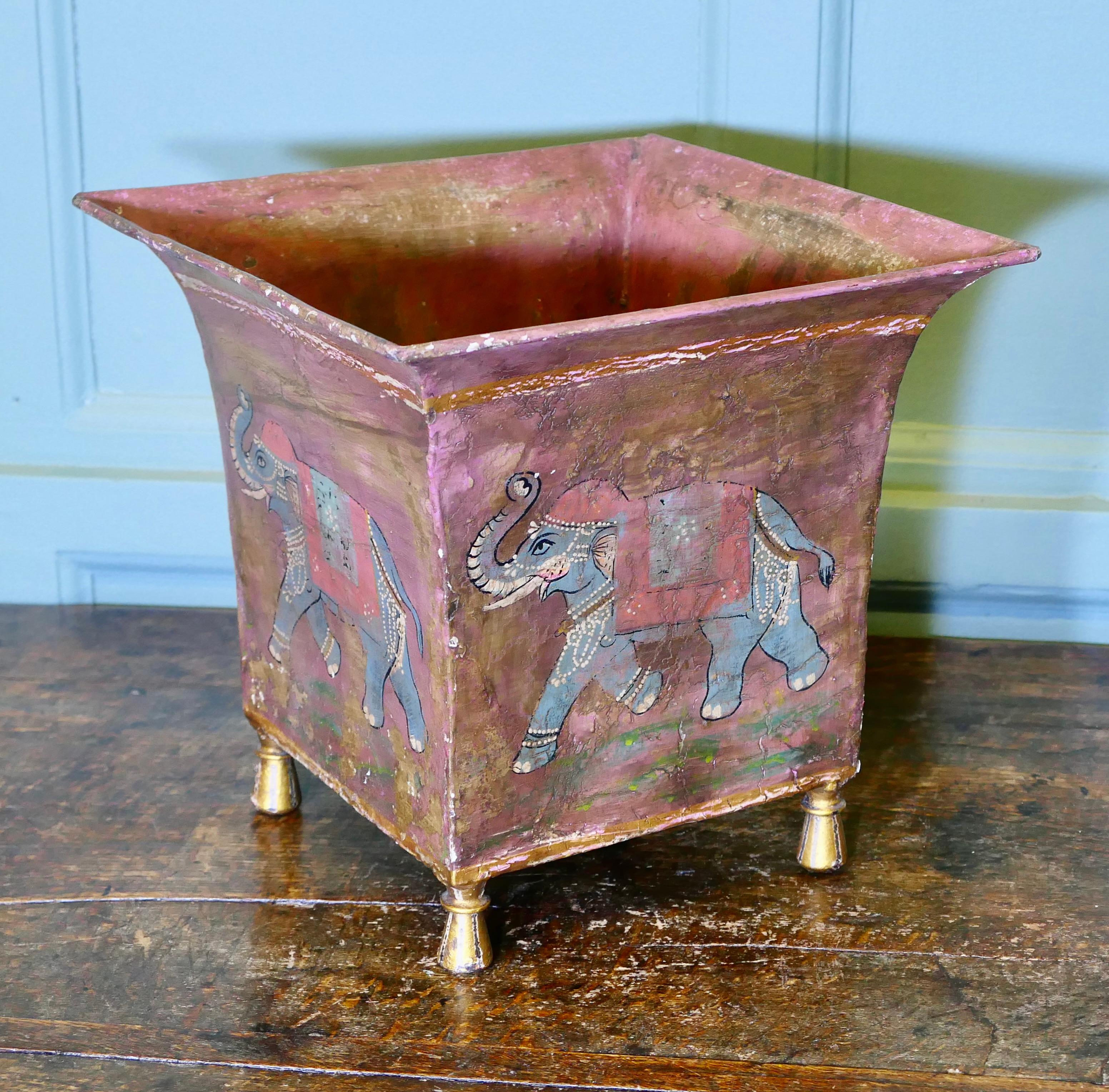 Indian Metal Jardiniere Painted with Elephants

Lovely and naive decoration with Elephants in full ceremonial dress, this is a  square container with a large folded top edge set on small feet, there are many uses for a versatile piece like this but