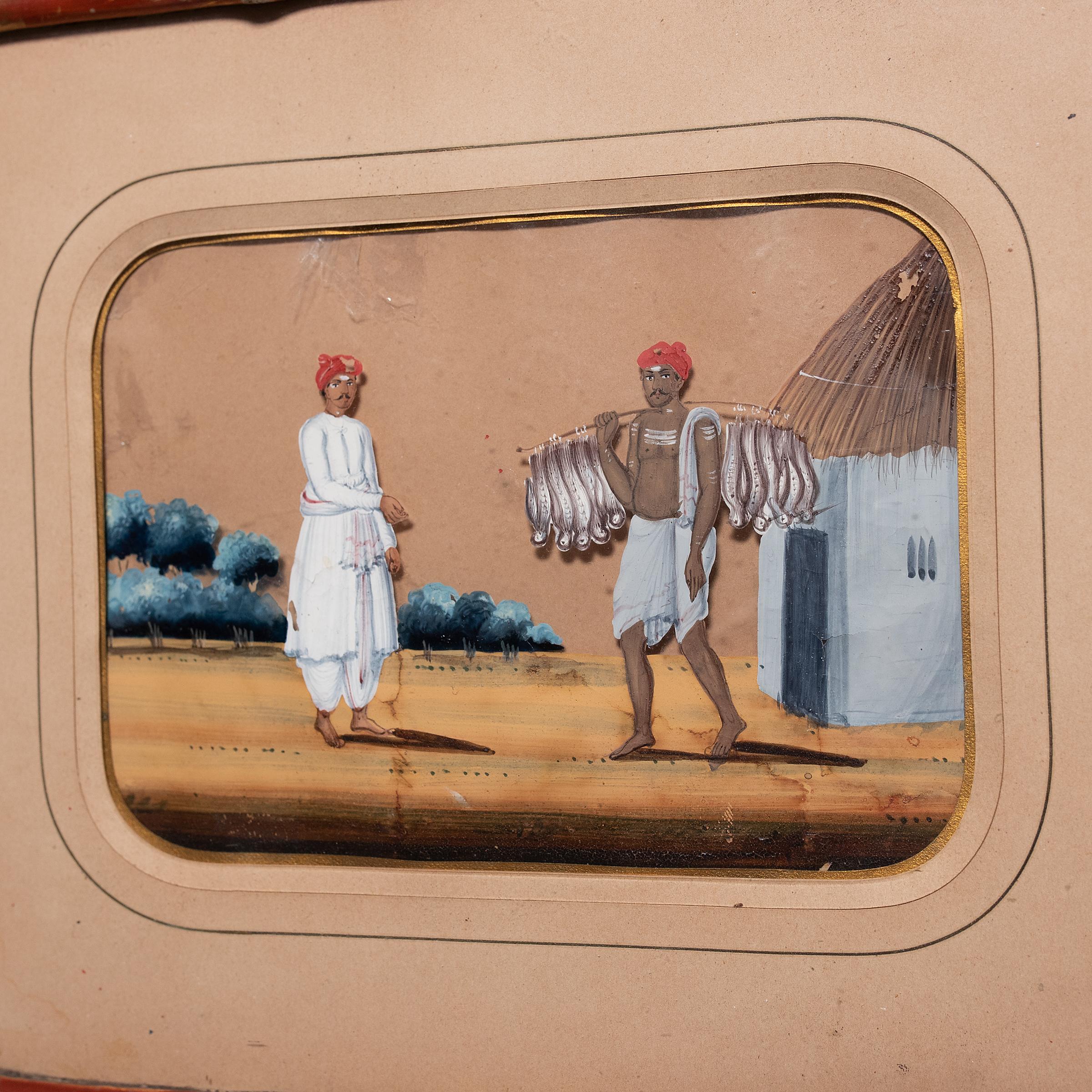Made with gouache paint and encased in a charming bamboo frame is this miniature Indian mica painting depicting village life in the 19th-century. Considered a novelty for the colonial tourist market, miniature mica paintings were commissioned by the