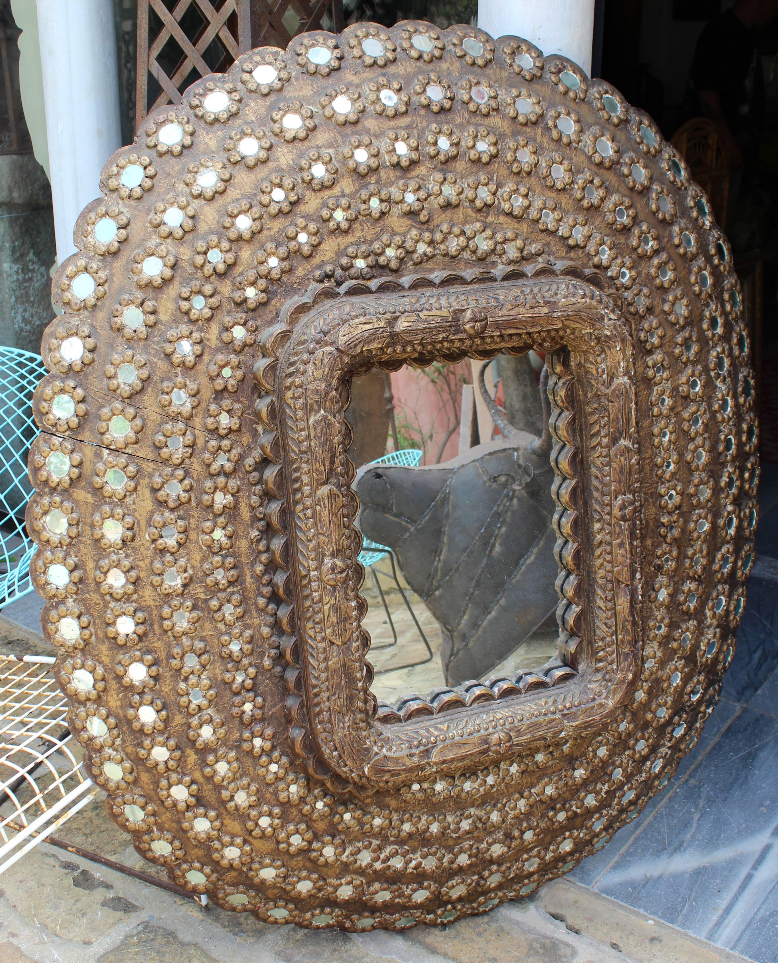 Decorative brown wooden frame with round inlayed pieces of glass.
 