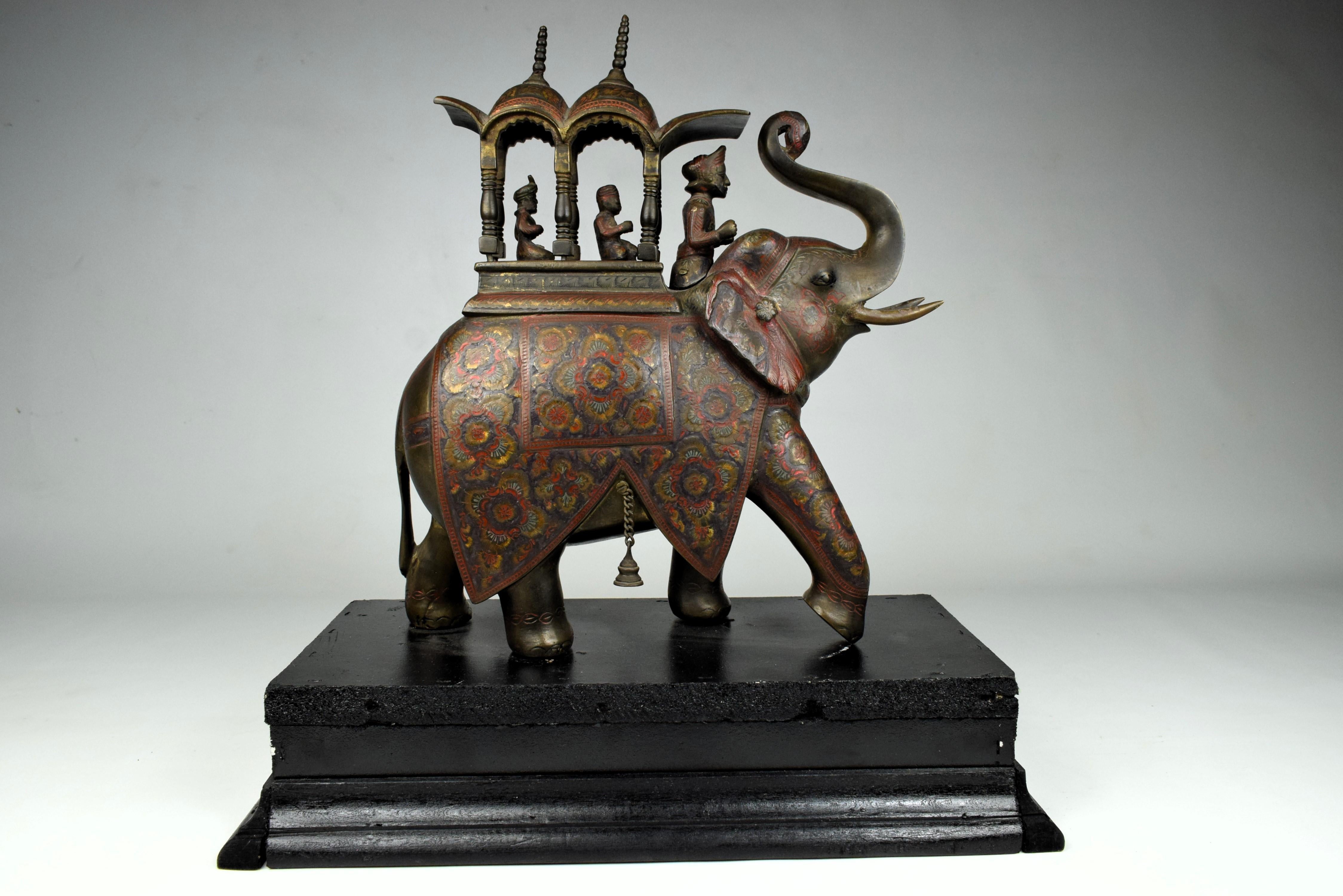 
A brass Mughal Indian Hathi Howdah (elephant saddle) carrying a rider and two royals, adorned with enamel work, is a majestic and opulent representation of Mughal artistry. 

The Hathi Howdah is a grand creation, showcasing the Mughal craftsmanship