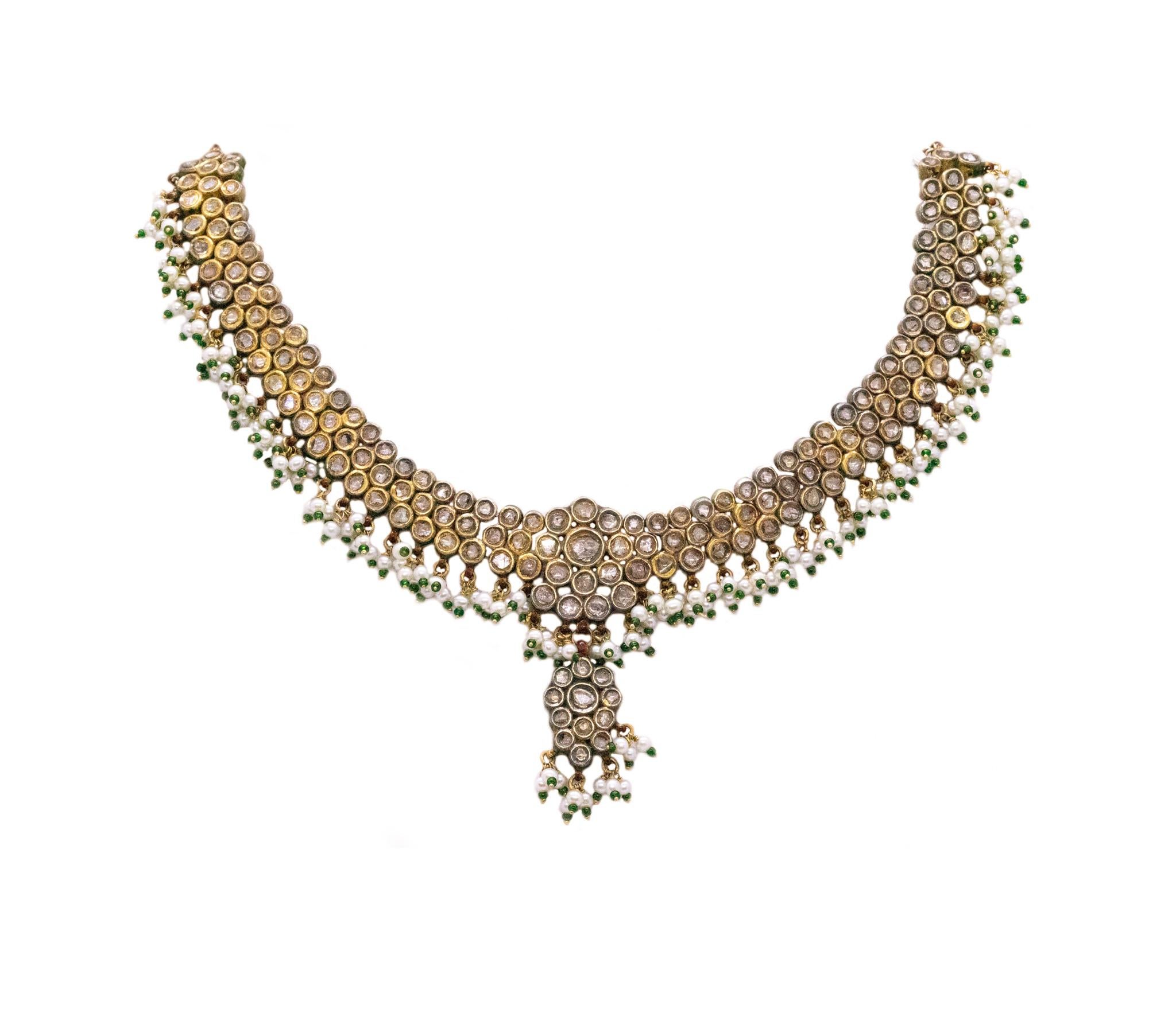 Stunning Mughal Court jeweled necklace.

Designed in India around the 1940's in the old Mughal jewelry style. This type of pieces are commonly used in Indian wedding festivities and was crafted in solid 21 karats (0.9166) of yellow gold. decorated