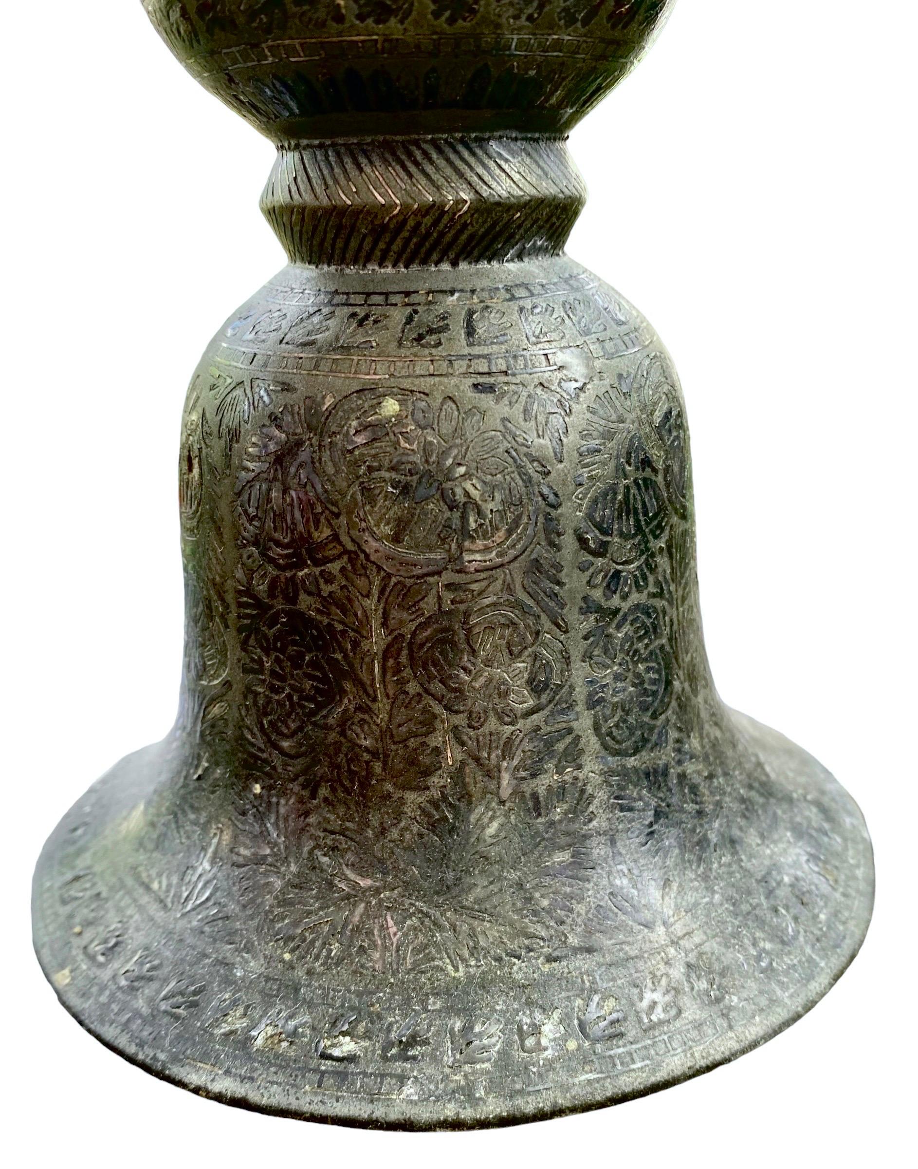 This antique, Indian bidri spitoon (Peekdaan or Thookadaan) is cast as an opposing double bell-shape, with the exterior decorated with oval reserves of stylized, poppies, a common motif in bidriware. From Bidar, Deccan in South West India.

