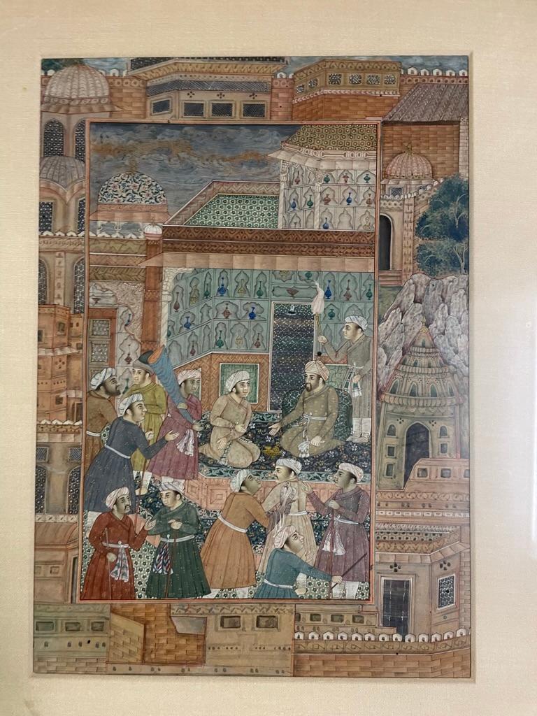 16th Century style Indian Mughal gouache manuscript page depicting a group of noblemen surrounding a royal figure in a beautiful interior with tiles and carpets as well as walls of niches holding elegant glass vessels. Framed by domed and tiled