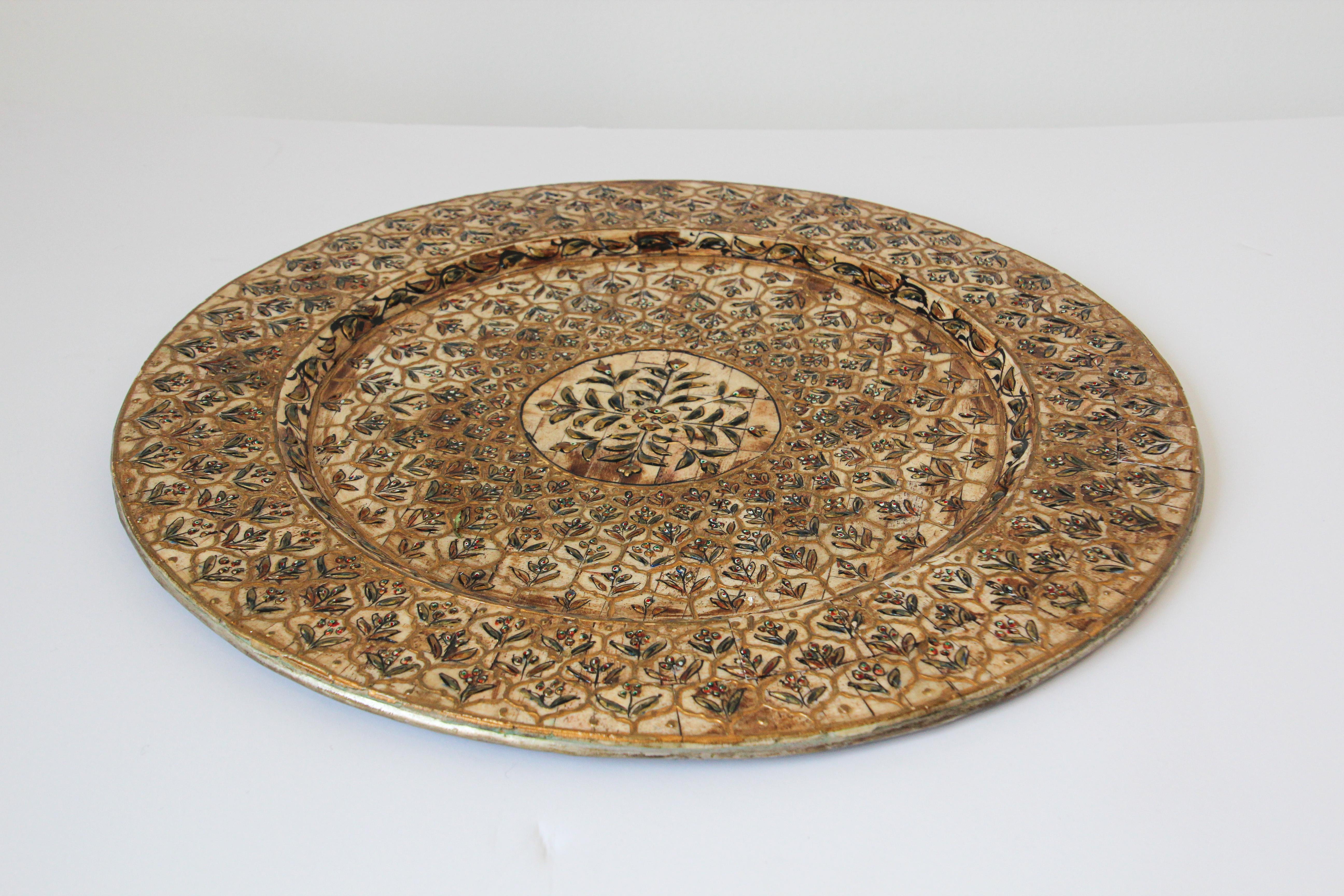 Indian Mughal style overlaid hand painted metal platter with gilt and polychrome floral design,.
Beautiful decorative platter overlaid and hand painted throughout in Moorish geometric design and Mughal Raj arabesque.
This stylish Mughal Raj plate is