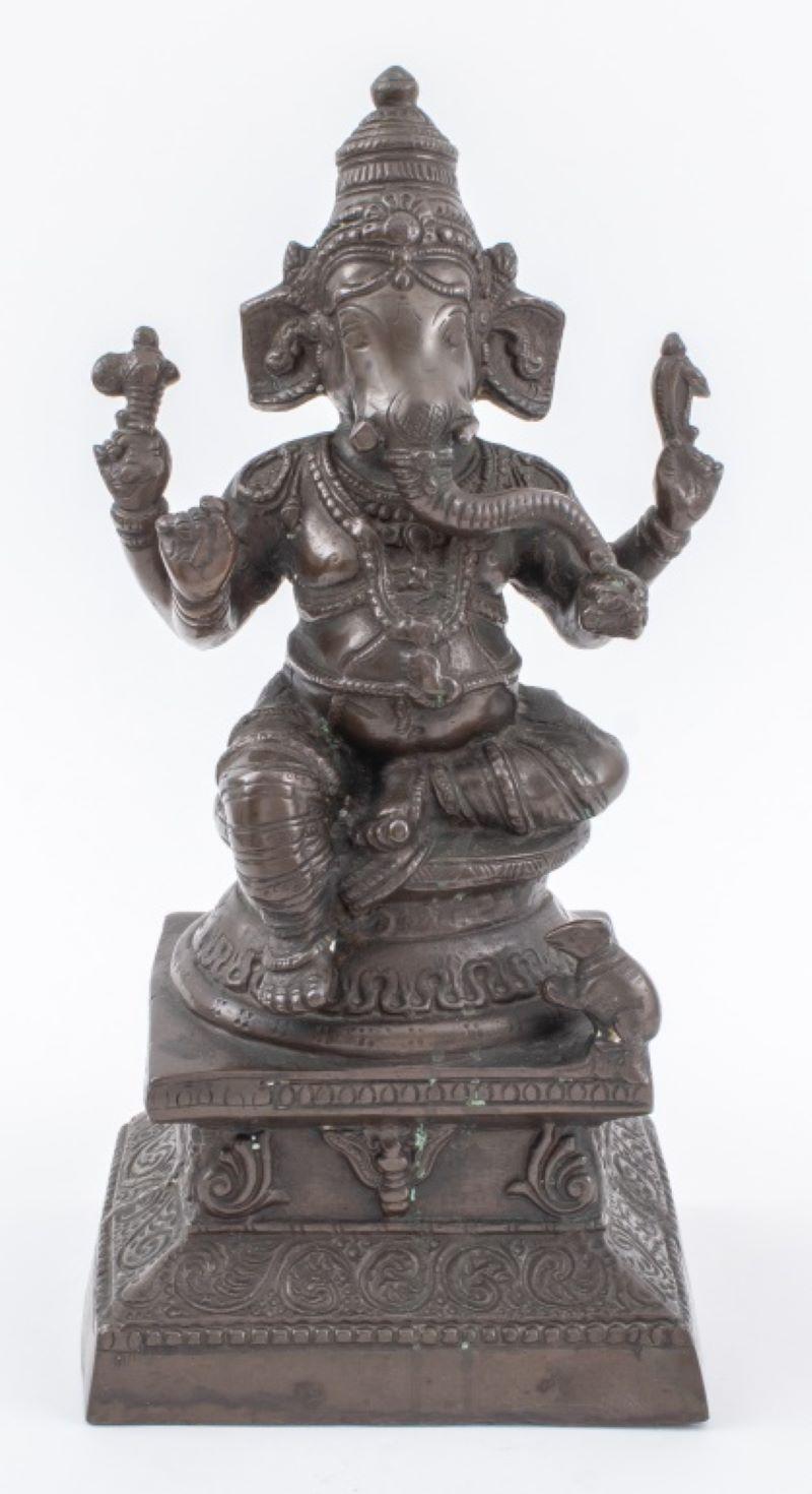 Antique Indian patinated brass statue sculpture of the Hindu Lord Ganesh seated on a lotus pedestal atop a tiered base with a mouse, cast with a scrolling foliate design. Measures: 14.5