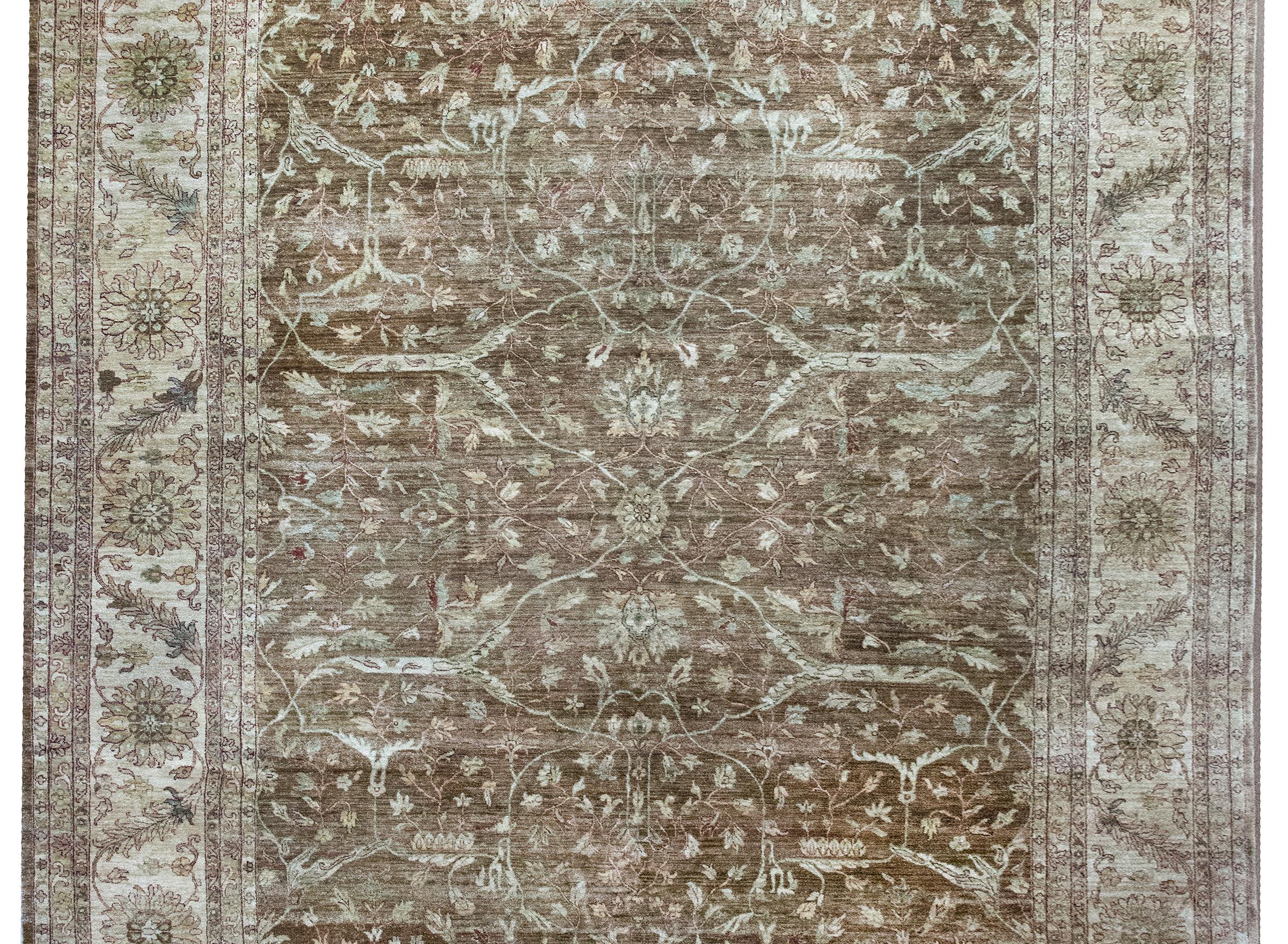 This late 20th-century Indian Peshawar rug draws inspiration from the classic Ziegler style, blending traditional Persian motifs with a softened, decorative palette. Woven with a mirrored tree-of-life pattern that repeats gracefully across the