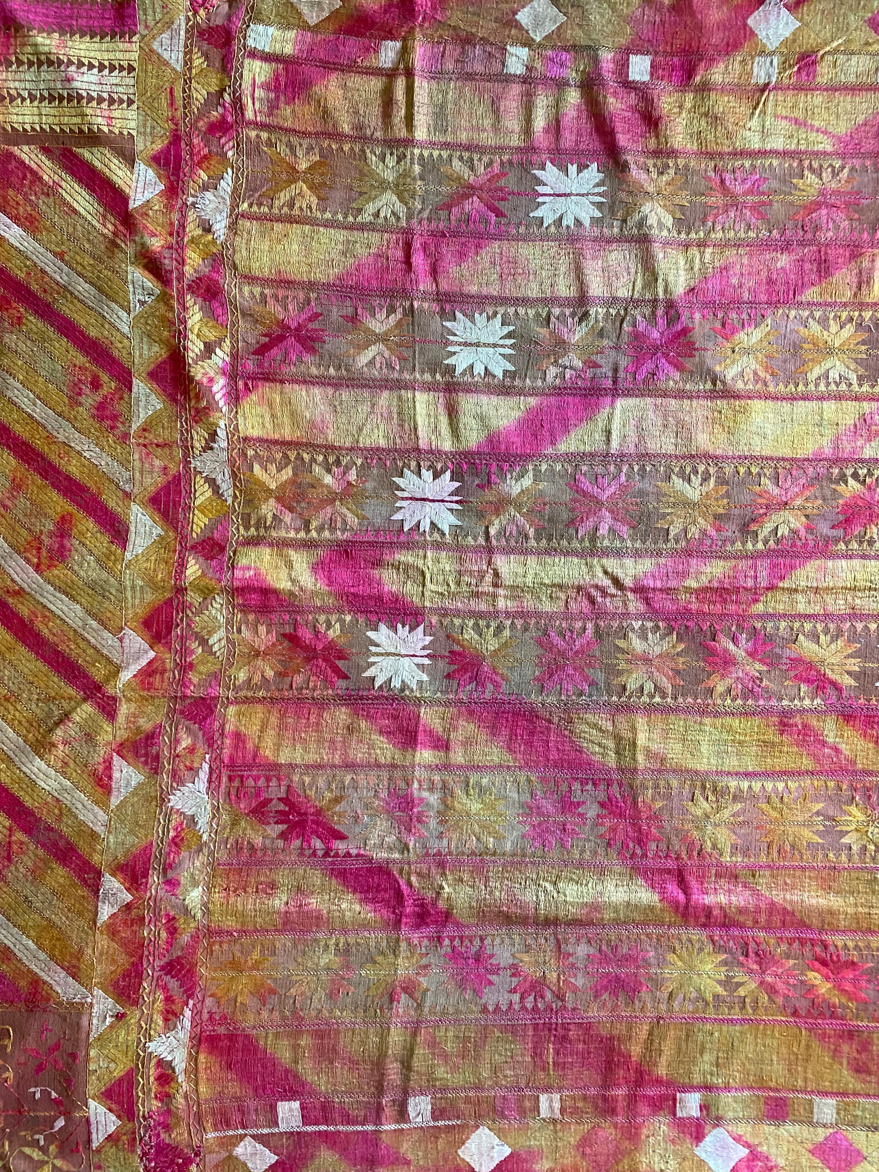 This strikingly coloured Phulkari is from Punjab, India. It was hand-crafted from silk and cotton, with silk being used for the embroidery. Phulkari’s are a form of wedding shawl and are used by bride’s amidst marriage ceremonies. What makes