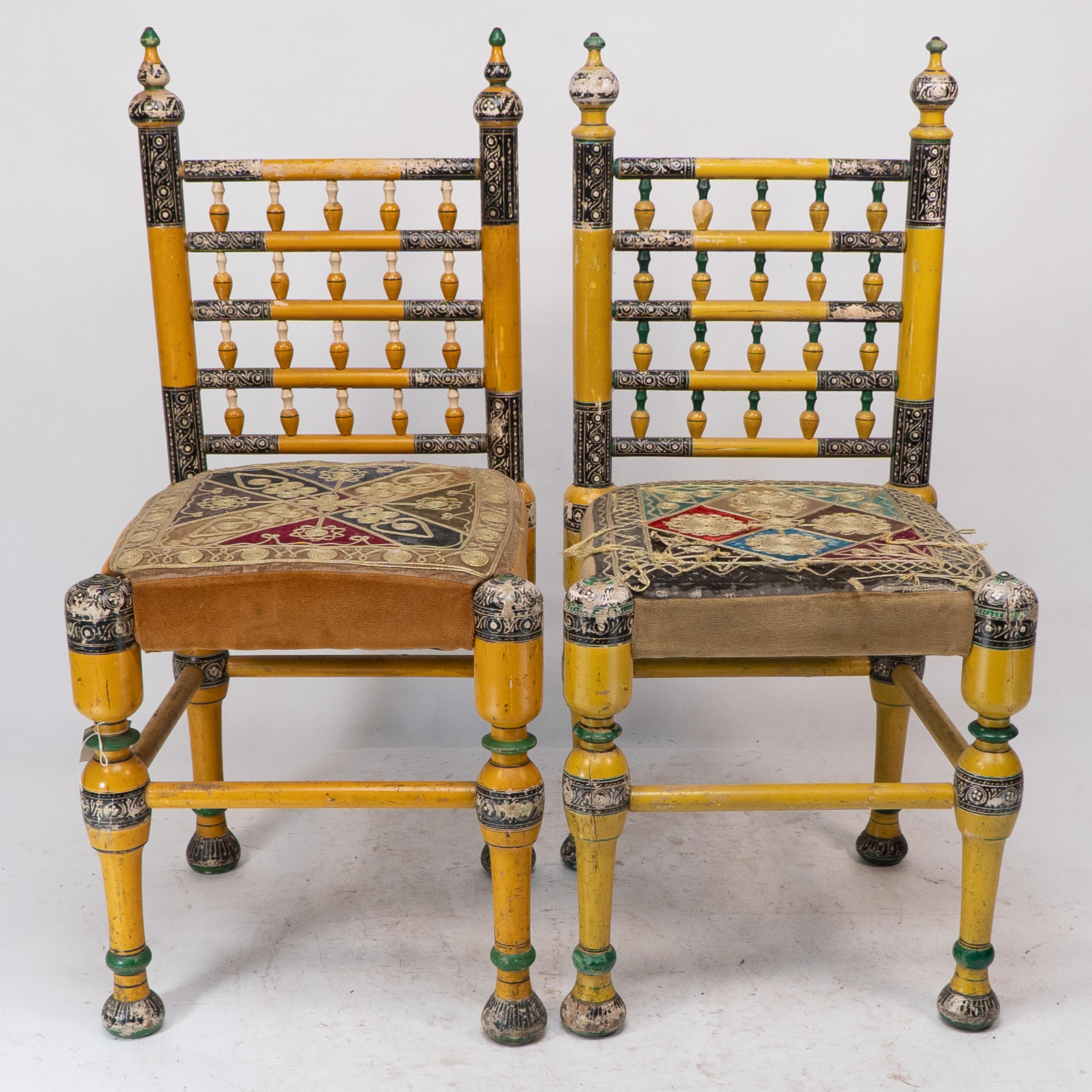 Indian Rajasthani. A rare pair of period side chairs finely painted in polychrome colours with the original floral gilt chord embroidery seats, the seats a little worn with minor losses to the paint. Price for the pair.
