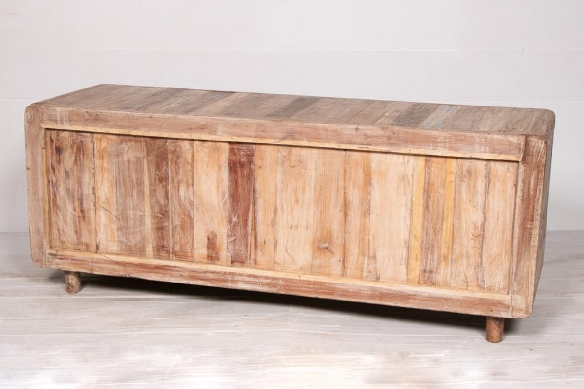 A tv stand made from reclaimed Indian teak with two drawers, a cubby and two cupboards.