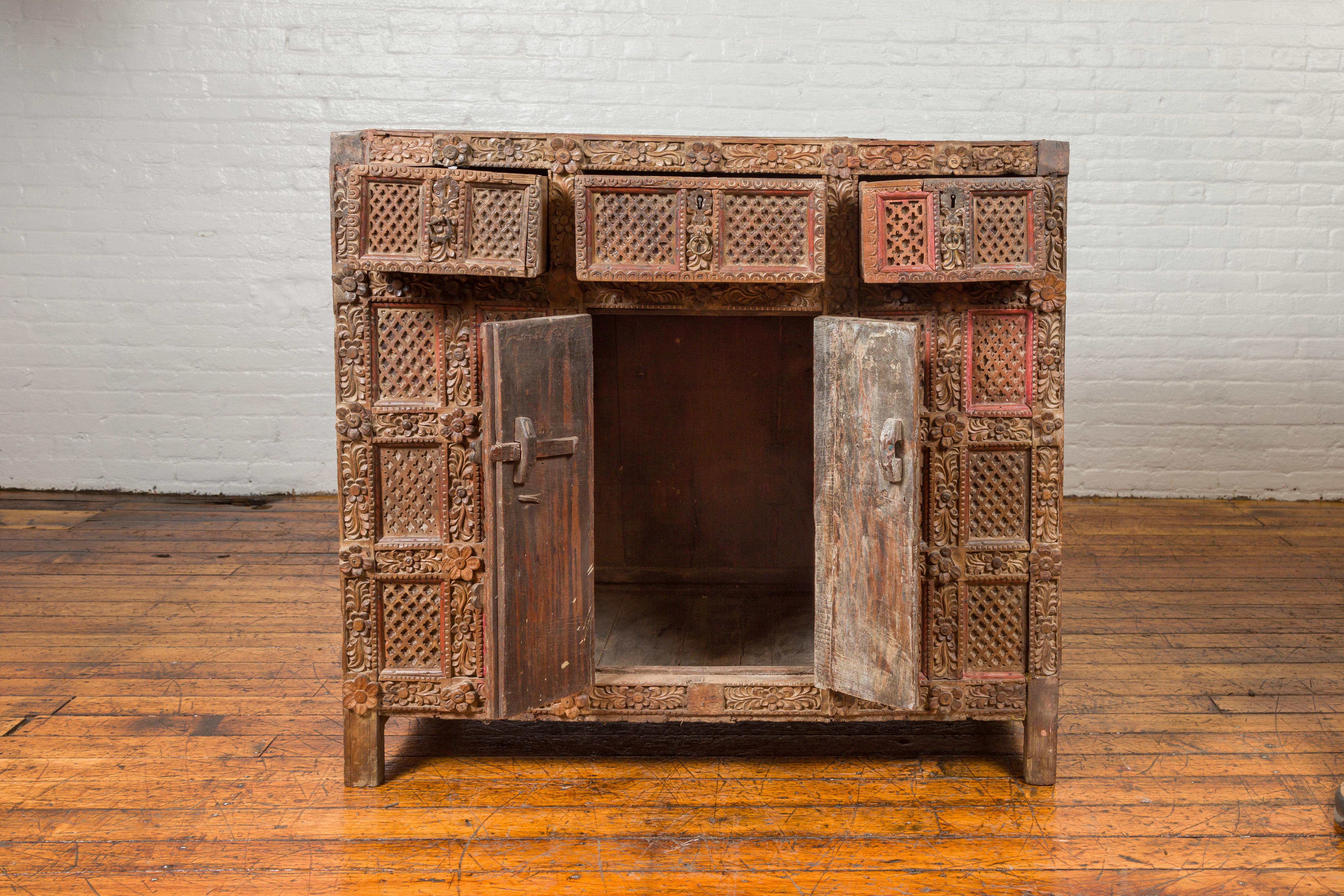 Indian Rubbed Wood Palace Cabinet with Carved Floral Decor and Red Patina In Good Condition In Yonkers, NY