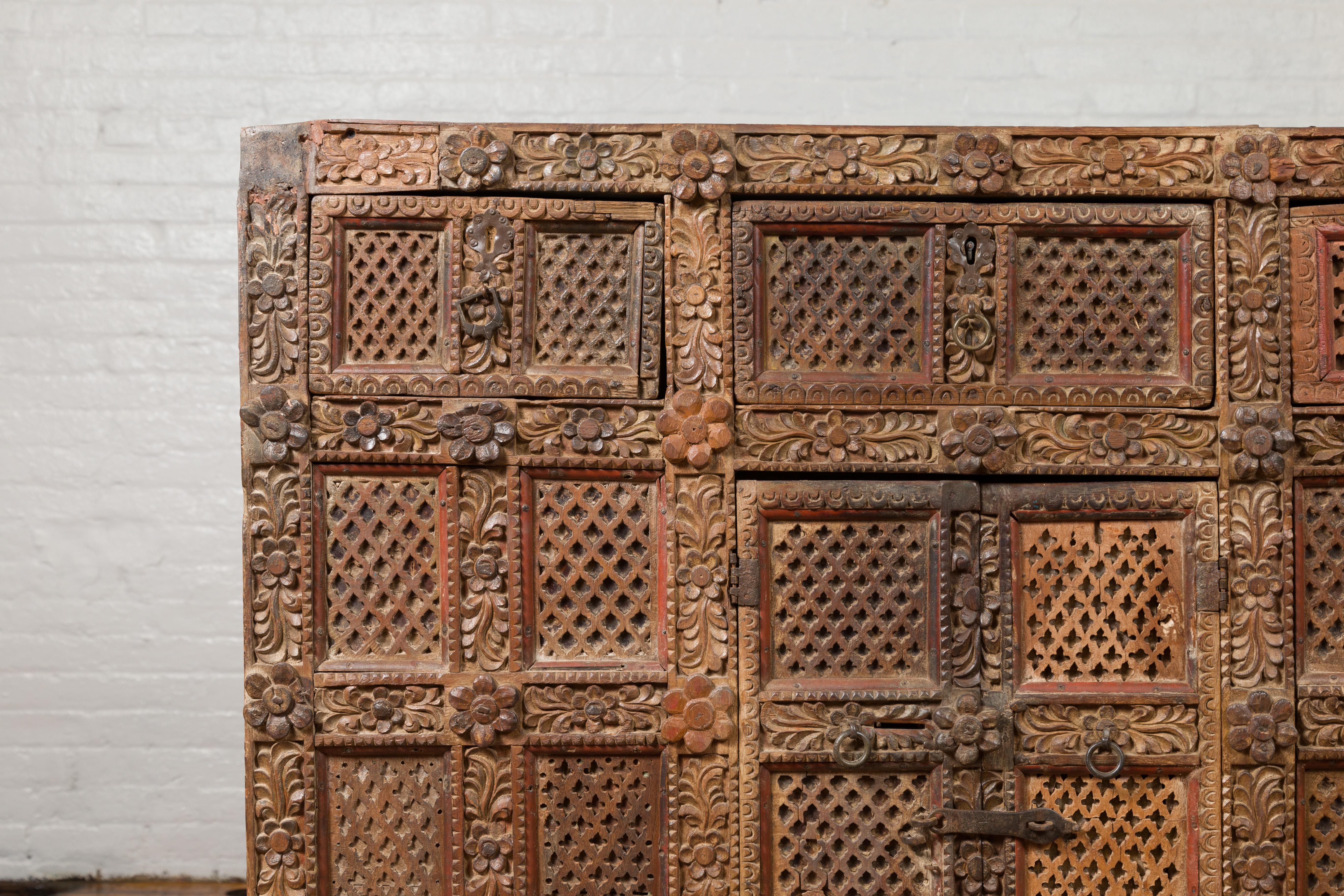 19th Century Indian Rubbed Wood Palace Cabinet with Carved Floral Decor and Red Patina