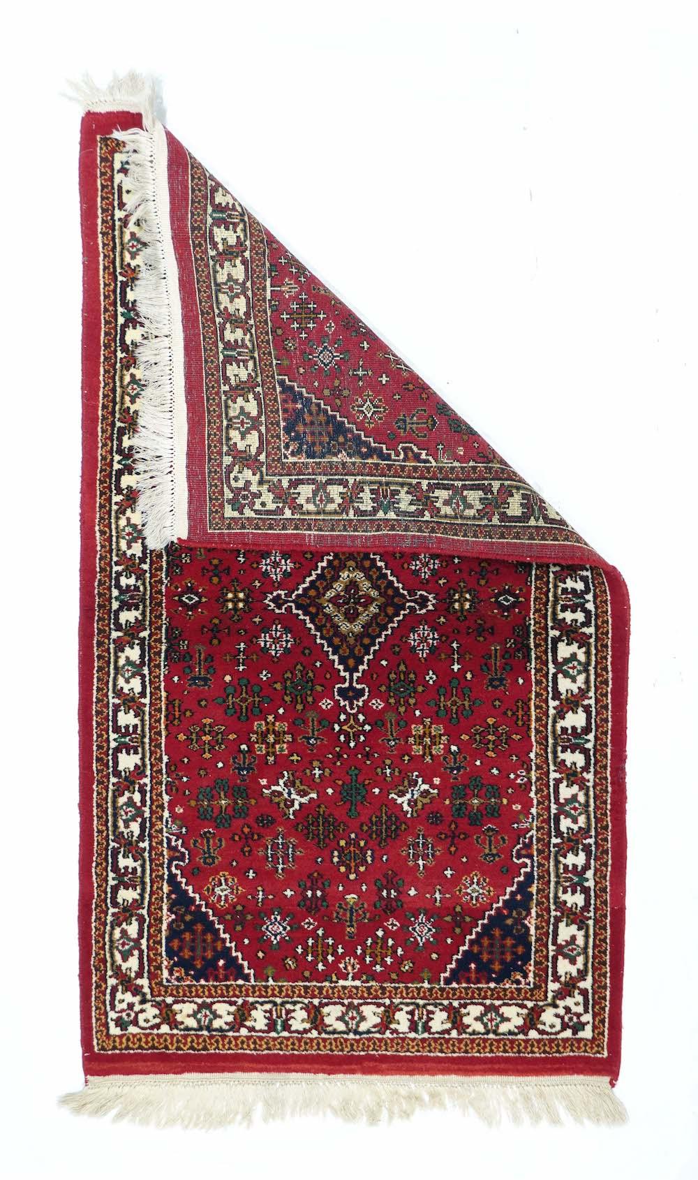 Indian Rug 2'11'' x 5'3''. In the Joshagan manner, with a red field displaying diamond-shaped floret arrays, stepped navy corners, and a matching stepped lozenge medallion. Ecru main border with palmette and scrolled, tilted leaves. Moderate weave.