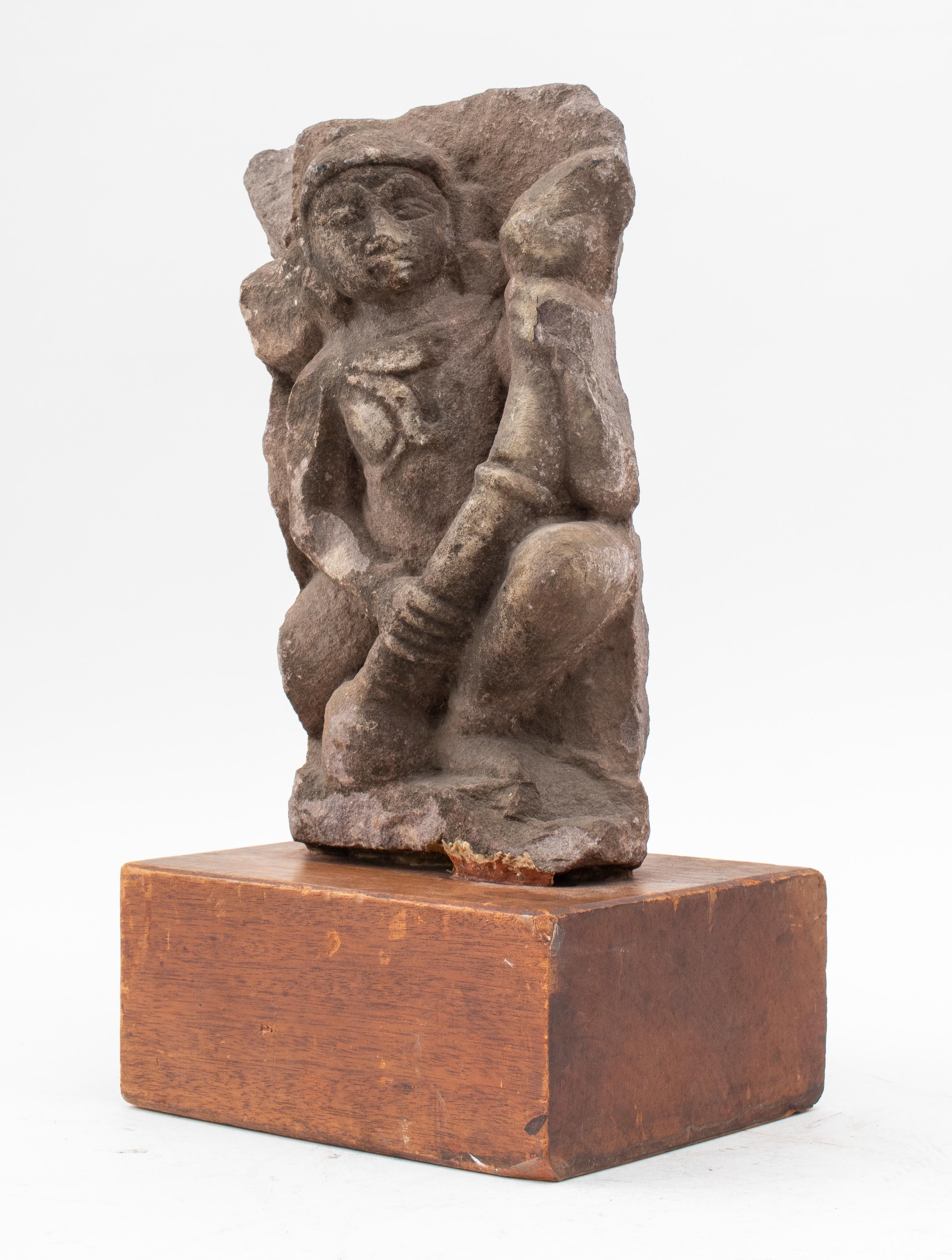 Antique Indian stone carving depicting Shiva, was likely once part of a large ancient altar idol sculpture with multiple deities, now mounted upon a hardwood stand. 
Measures: 18.5