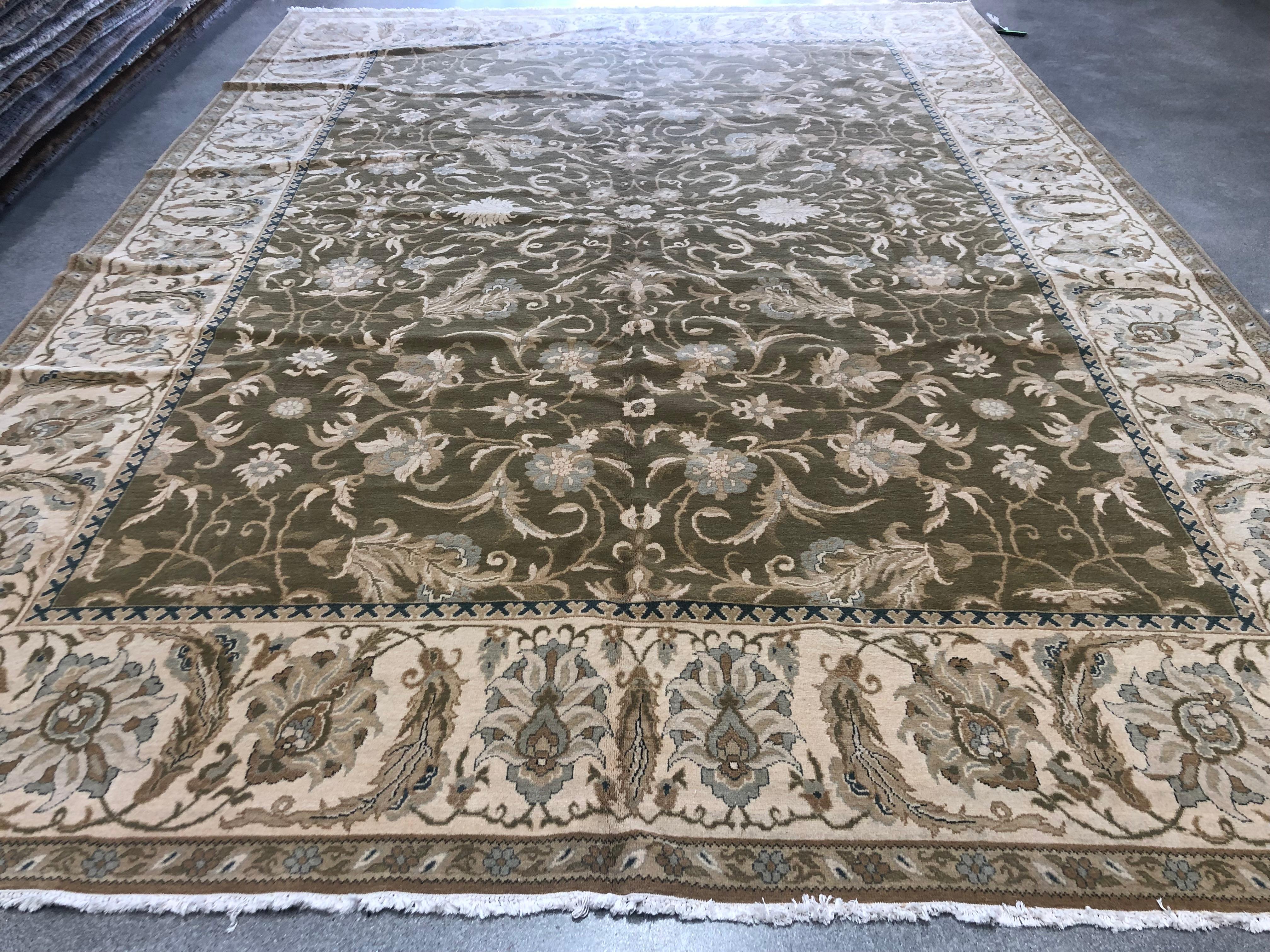 Ajoutez de l'élégance à n'importe quel espace avec l'ajout de ce magnifique tapis d'appoint floral de style Savonnerie. Des tons doux de vert, de beige, d'or et de bleu, des feuilles en plumes et des fleurs douces, tous ces éléments s'unissent pour