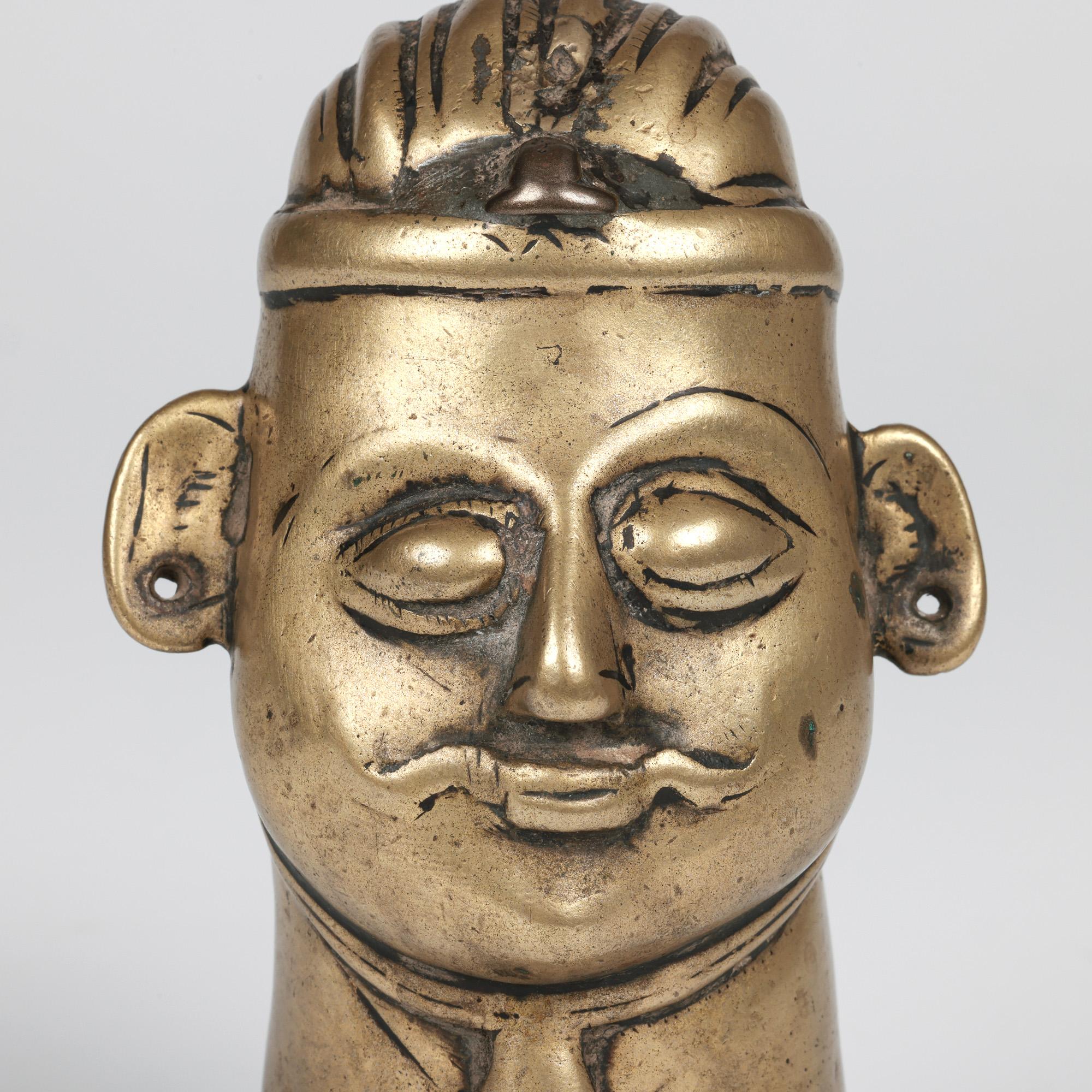 An antique Indian Shiva Mukhalingam made from a brass alloy and formed as a human face dating from the 18th century.

The Shiva Mukhalingam has a single face (some come with four or five faces) and is hollow formed as a sheath and is placed over a