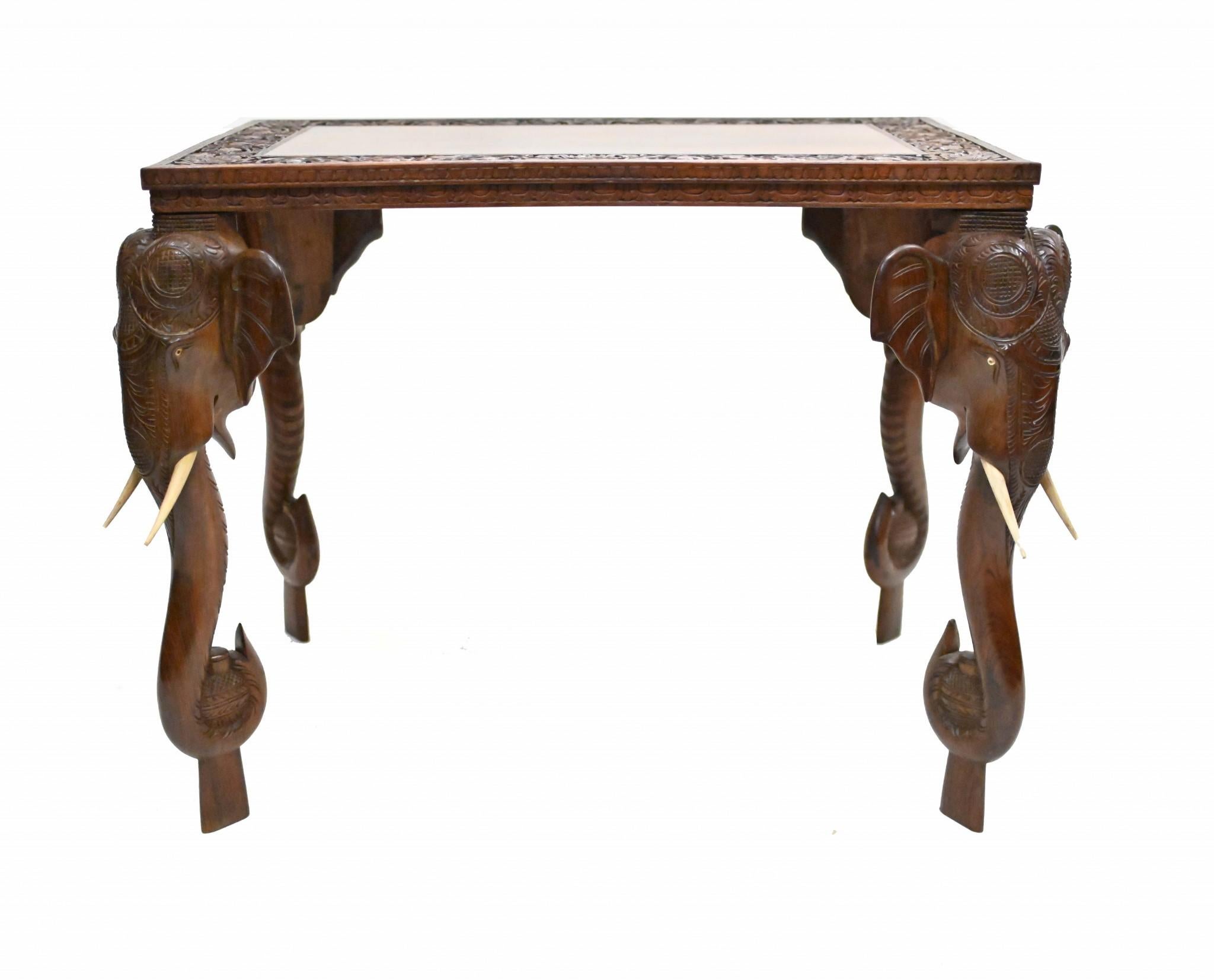 Highly collectable Colonial side table crafted from teak wood
Originally from India - possibly Goan - so great piece of history
Features four elephant heads with trunks for the legs and carved wood for the faux ivory tusks
We date this piece to