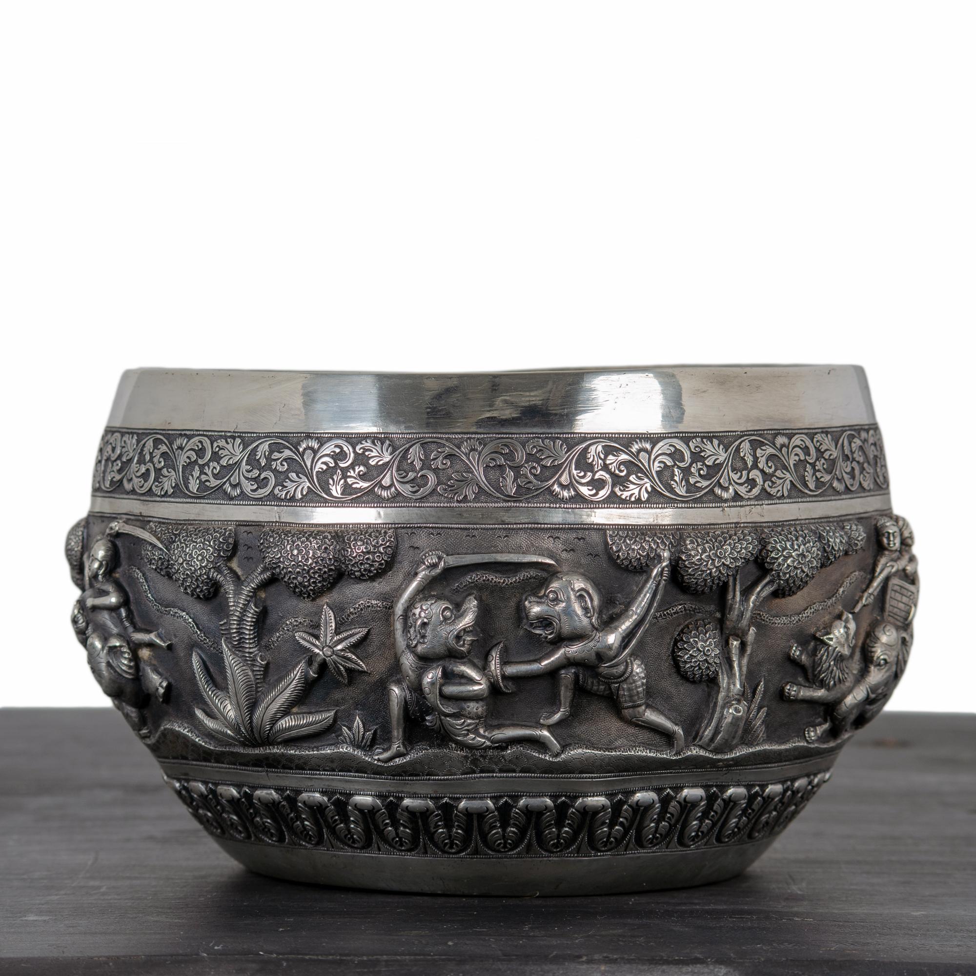 A large repoussé silver ceremonial hunting bowl, Lucknow, North India, Raj Period, late 19th century. 

Five scenes depicting mythological creatures, lion and boar hunt scenes with foliate ornamentation.  Elephant and tree mark on underside; see