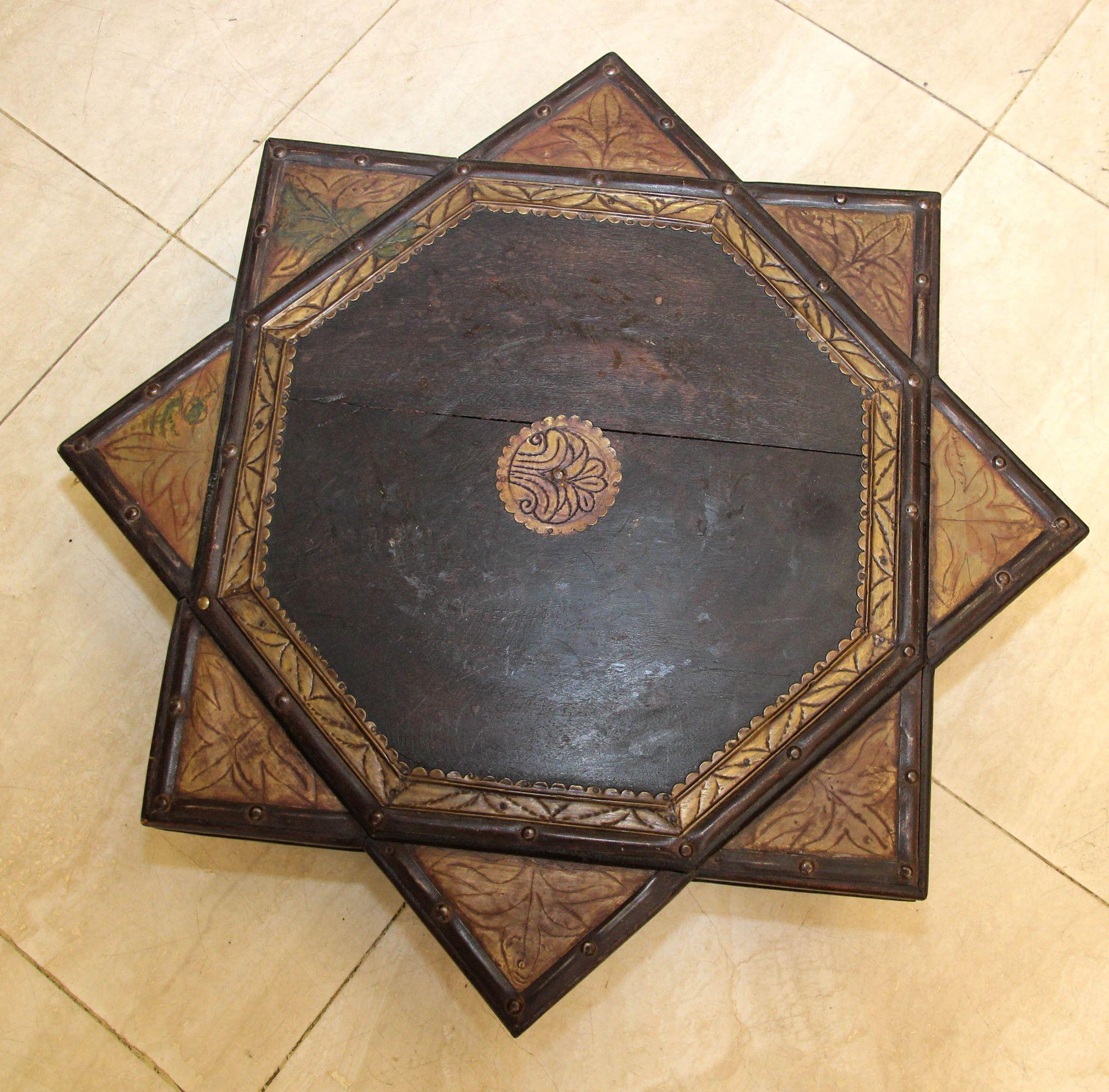 Indian wooden low coffee table in the shape of 8 pointed star decorated with embossed brass accents and nails.
This teak bajot low table from Rajasthan has a gorgeous rich patina and lots of character with beautiful signs of age and use.
Classic