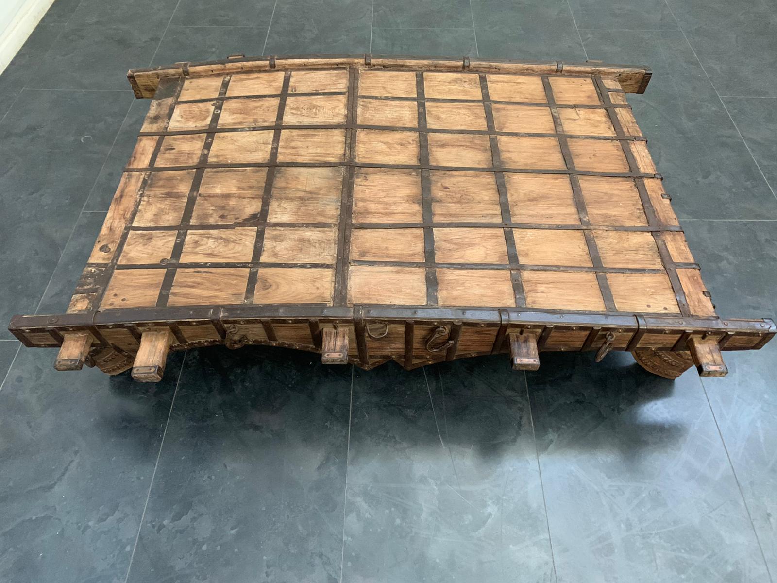 Large Indian teak and wrought iron coffee table.