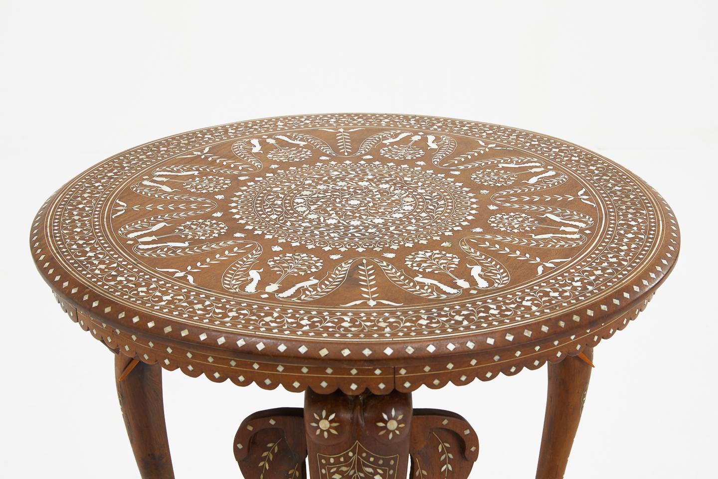 Excellent quality, beautifully inlaid, Indian teak and bone occasional table with elephant legs, circa 1920.
 