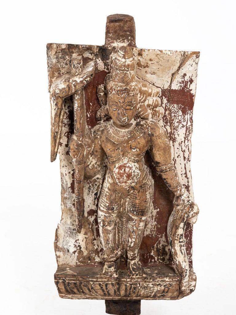 Wooden Indian temple carving of a figure on stand, circa 19th century. Please note of wear consistent with age including original patina and paint loss throughout.