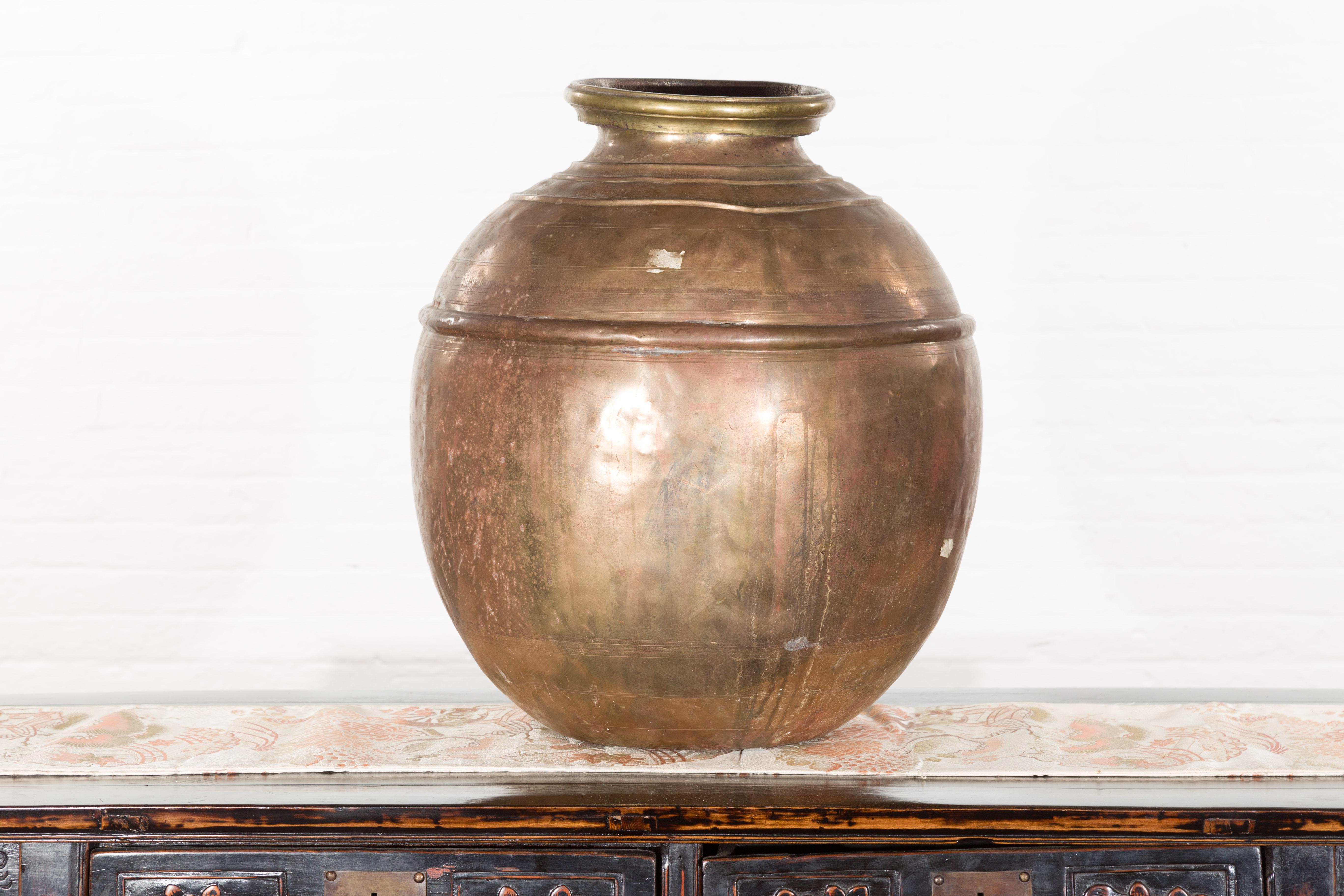 20th Century Indian Vintage Brass Water Jar with Concentric Rings and Distressed Appearance