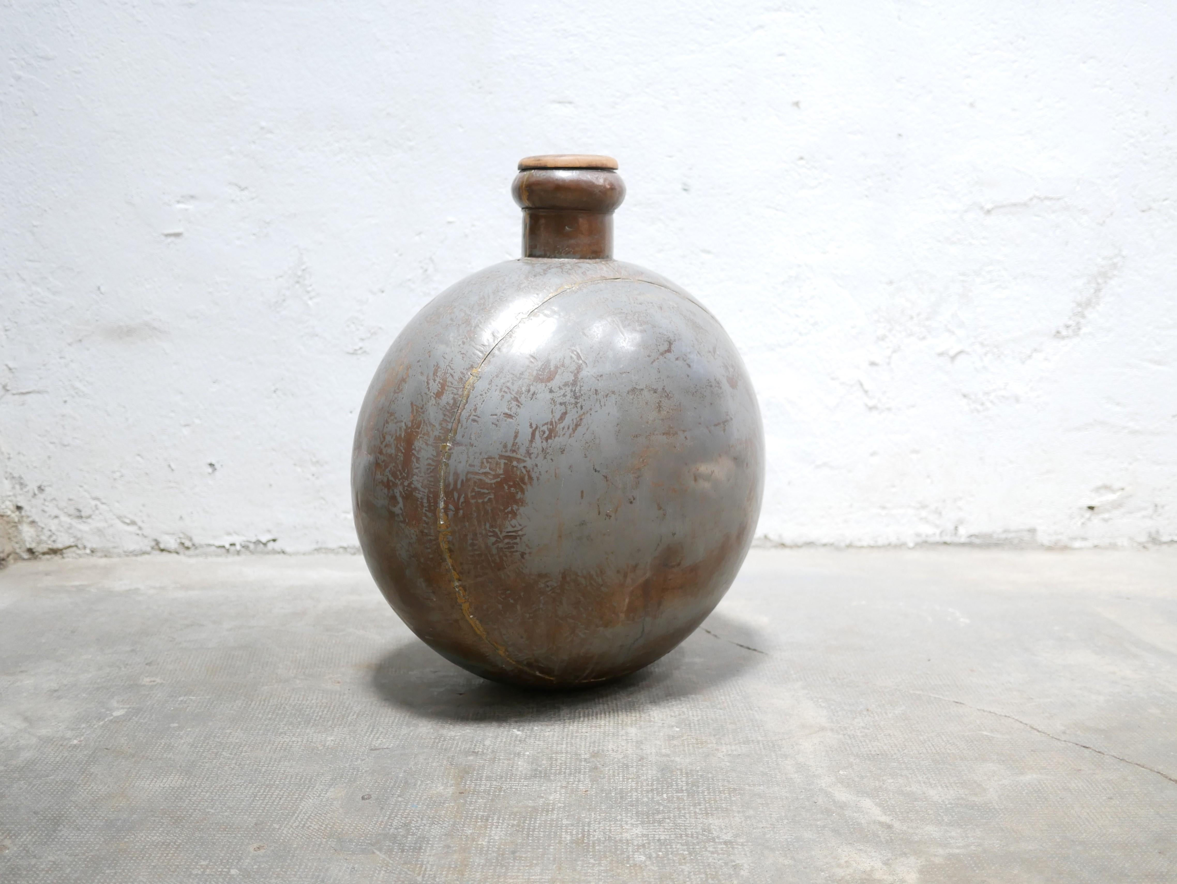 Metal water bottle designed in Rajasthan, India, early 20th century.

With its modern shape, its raw material and its pretty patina, this object is very decorative.
Placed on the floor or on a piece of furniture, it will bring a lot of character and